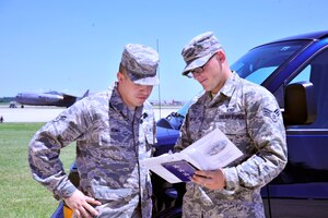 11th Logistic Readiness Squadron Protocol Services vehicle operators Senior Airman Steven Wirth and Airman 1st Class Gerald Romo exchange insight on guidelines for transporting distinguished visitors outside of Secretary of the Air Force Michael B. Donley’s farewell ceremony held at Joint Base Andrews' Hangar Three on June 21, 2013. The National Capital Region averages 1,500 distinguished visitor requests annually. (U.S. Air Force photo/ Staff Sgt. Amber Russell)