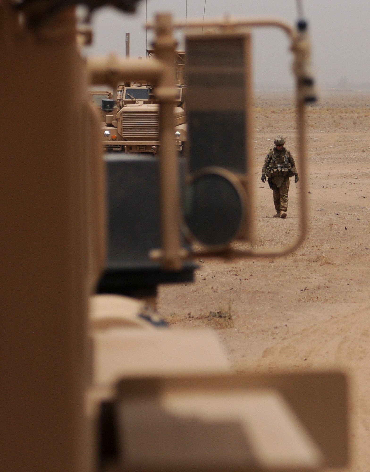 A U.S. Army explosive ordnance disposal technician surveys the area after a controlled detonation outside of Kandahar Airfield, Afghanistan, June 12, 2013. Following the joint mission to dispose of excess military ordnance, U.S. Army, U.S. Air Force, Australian and Slovakian EOD technicians examined the blast site to determine the total destruction of the munitions in the controlled detonation, or if additional clean up would be required, while Romanian soldiers provided security for the site. (U.S. Air Force photo/Capt. Brian Maguire)