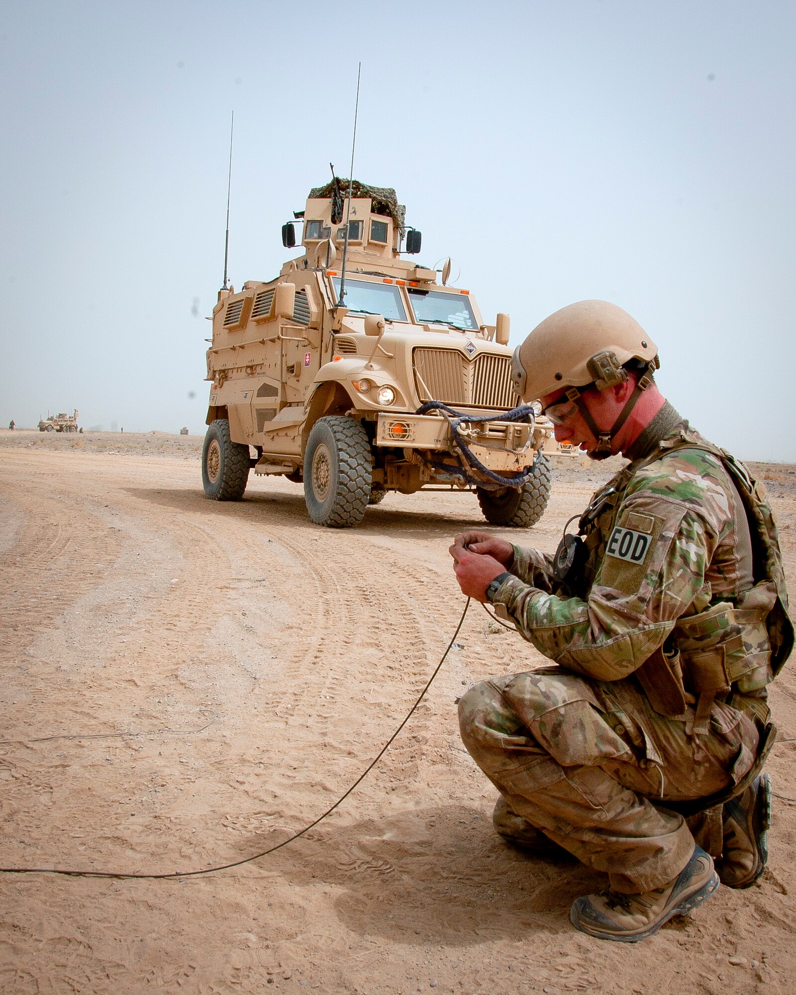U.S. Air Force Senior Airman Kyle Miller, 466th Air Expeditionary Squadron Explosive Ordnance Disposal technician and Hampstead, Md., native, connects detonation cord to a controlled detonation outside of Kandahar Airfield, Afghanistan, June 12, 2013. U.S. Air Force, U.S. Army, Slovakian and Australian EOD personnel participated in a joint mission to dispose of excess military ordnance. Miller is deployed from Barksdale Air Force Base, La. (U.S. Air Force photo/Senior Airman Scott Saldukas)