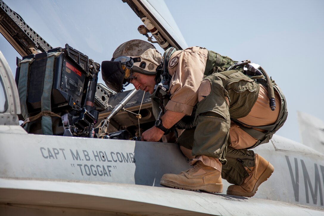 Marine Captain Matthew Holcomb from the VMFA-115 squadron perform pre-flight checks on the F-18 aircraft prior to takeoff. The Marine Fighter Attack squadron is operating out of a training base in Northern Jordan and is performing training and exercise missions as part of the Eager Lion exercise. Eager Lion is a U.S. Central Command-directed, irregular warfare-themed exercise focusing on missions the United States and its coalition partners might perform in support of global contingency operations. (U.S. Air National Guard photo by Senior Master Sgt. John P. Rohrer)