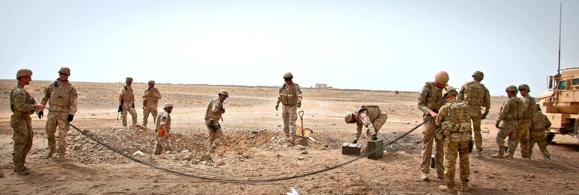 Joint-coalition forces prepare multiple controlled detonations to dispose of excess military ordnance near Kandahar Airfield, Afghanistan, to June 12, 2013. U.S. Air Force, U.S. Army, Slovakian and Australian explosive ordnance disposal personnel, along with Romanian soldiers providing security, participated in in the mission. (U.S. Air Force photo/Senior Airman Scott Saldukas)