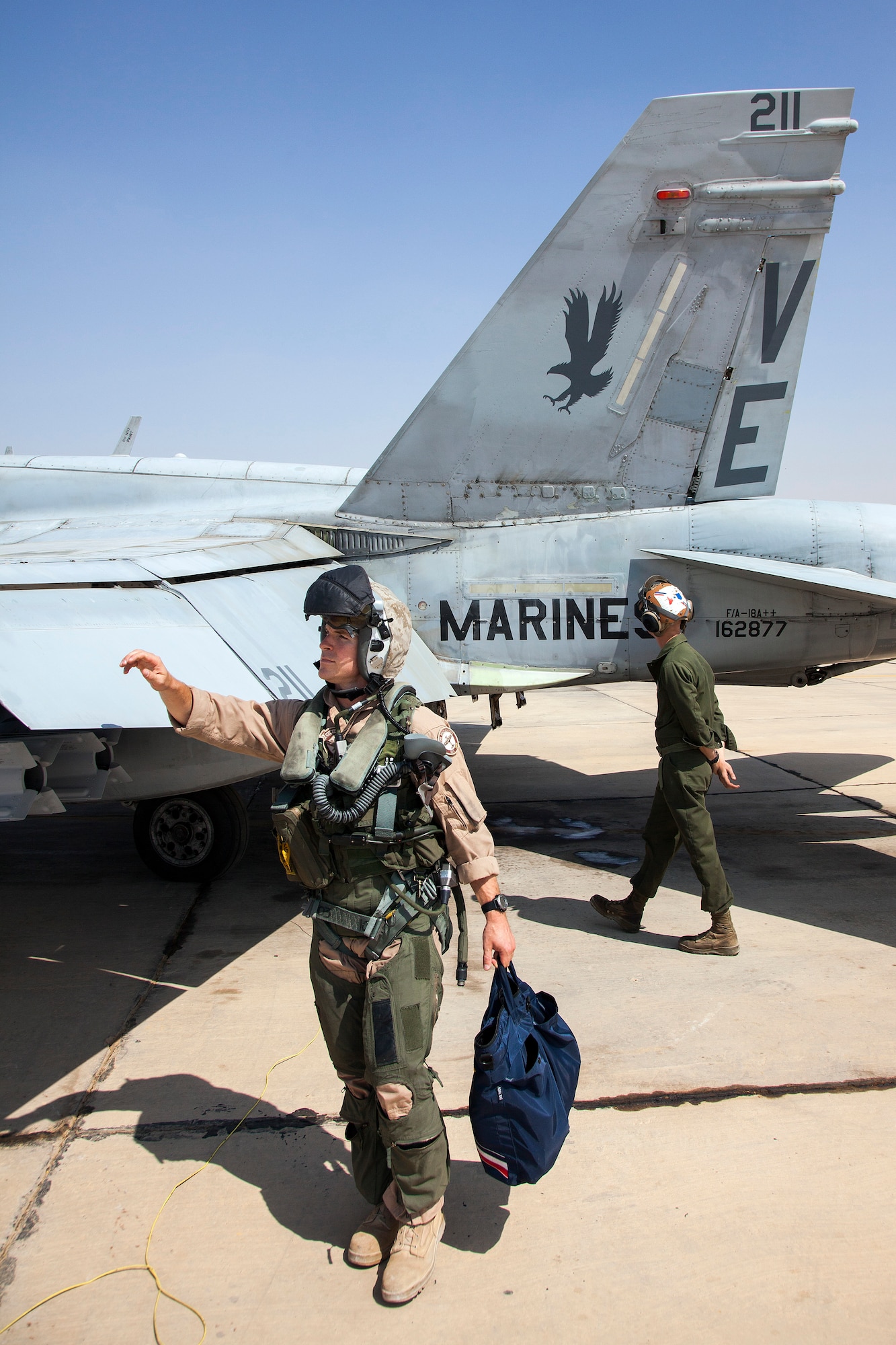 Marine Captain Matthew Holcomb and Lance Cpl. Aaron Broering from the VMFA-115 squadron perform pre-flight checks on the F-18 aircraft prior to takeoff. The Marine Fighter Attack squadron is operating out of a training base in Northern Jordan and is performing training and exercise missions as part of the Eager Lion exercise. Eager Lion is a U.S. Central Command-directed, irregular warfare-themed exercise focusing on missions the United States and its coalition partners might perform in support of global contingency operations. (U.S. Air National Guard photo by Senior Master Sgt. John P. Rohrer)