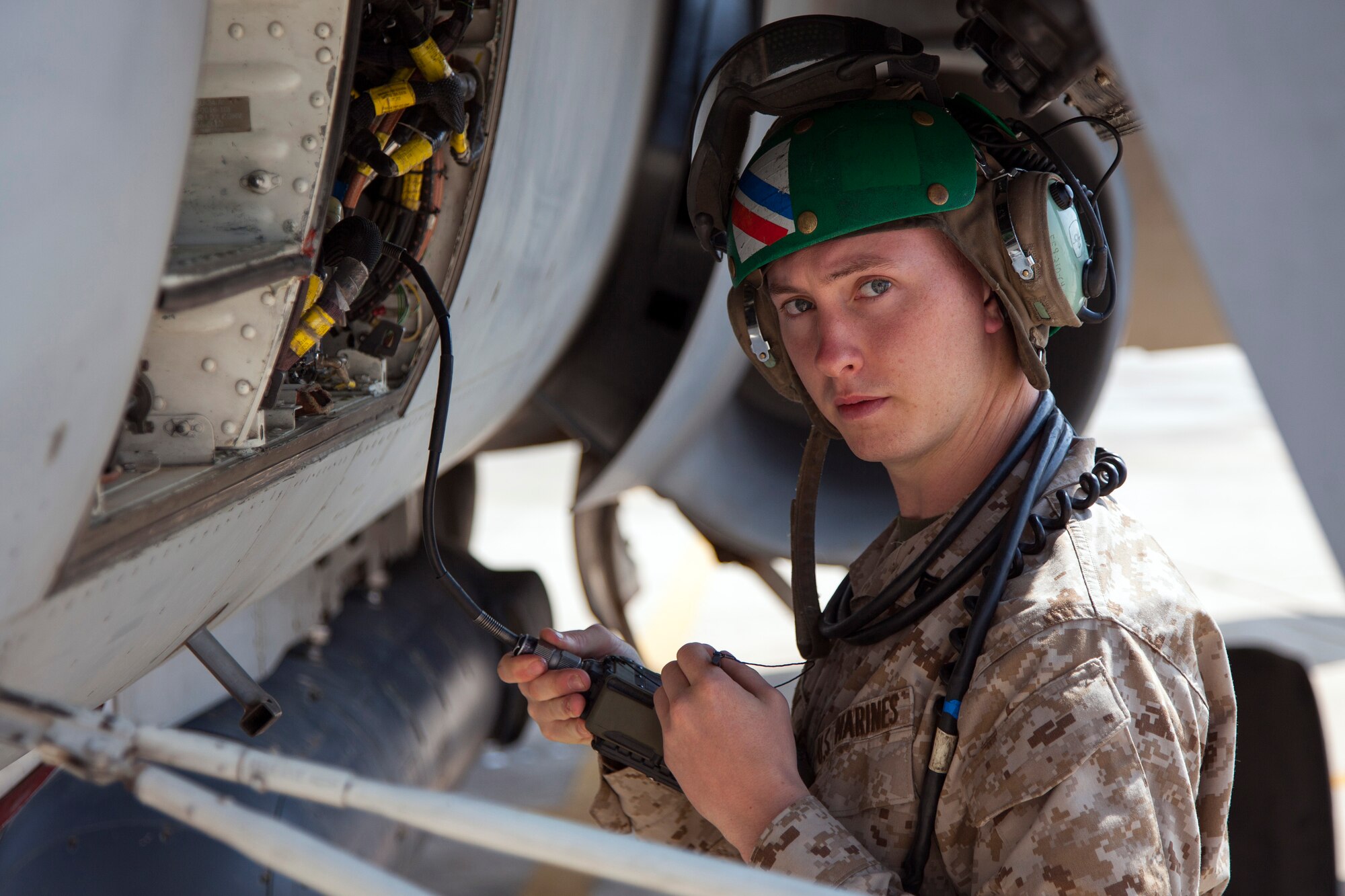 A Marine plane captain from the VMFA-115 squadron checks readings as the F-18 aircraft prepares for flight. The Marine Fighter Attack squadron is operating out of a training base in Northern Jordan as part of the Eager Lion exercise. Eager Lion is a U.S. Central Command-directed, irregular warfare-themed exercise focusing on missions the United States and its coalition partners might perform in support of global contingency operations. (U.S. Air National Guard photo by Senior Master Sgt. John P. Rohrer)