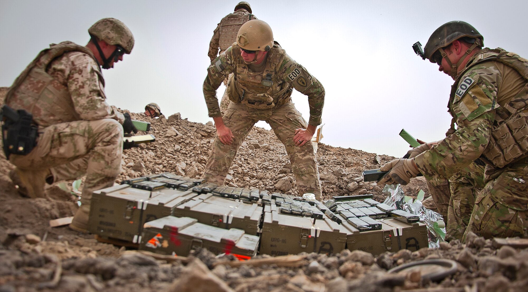 (Middle) U.S. Air Force Tech. Sgt. Matthew Stark, 466th Air Expeditionary Squadron Explosive Ordnance Disposal technician and Amherst, N.Y., native, oversees the construction of a controlled detonation by joint-coalition forces June 12, 2013, near Kandahar Airfield, Afghanistan. U.S. Air Force, U.S. Army, Slovakian and Australian EOD personnel participated in a joint mission to dispose of excess military ordnance. Stark is deployed from Dyess Air Force Base, Texas. (U.S. Air Force photo/Senior Airman Scott Saldukas)