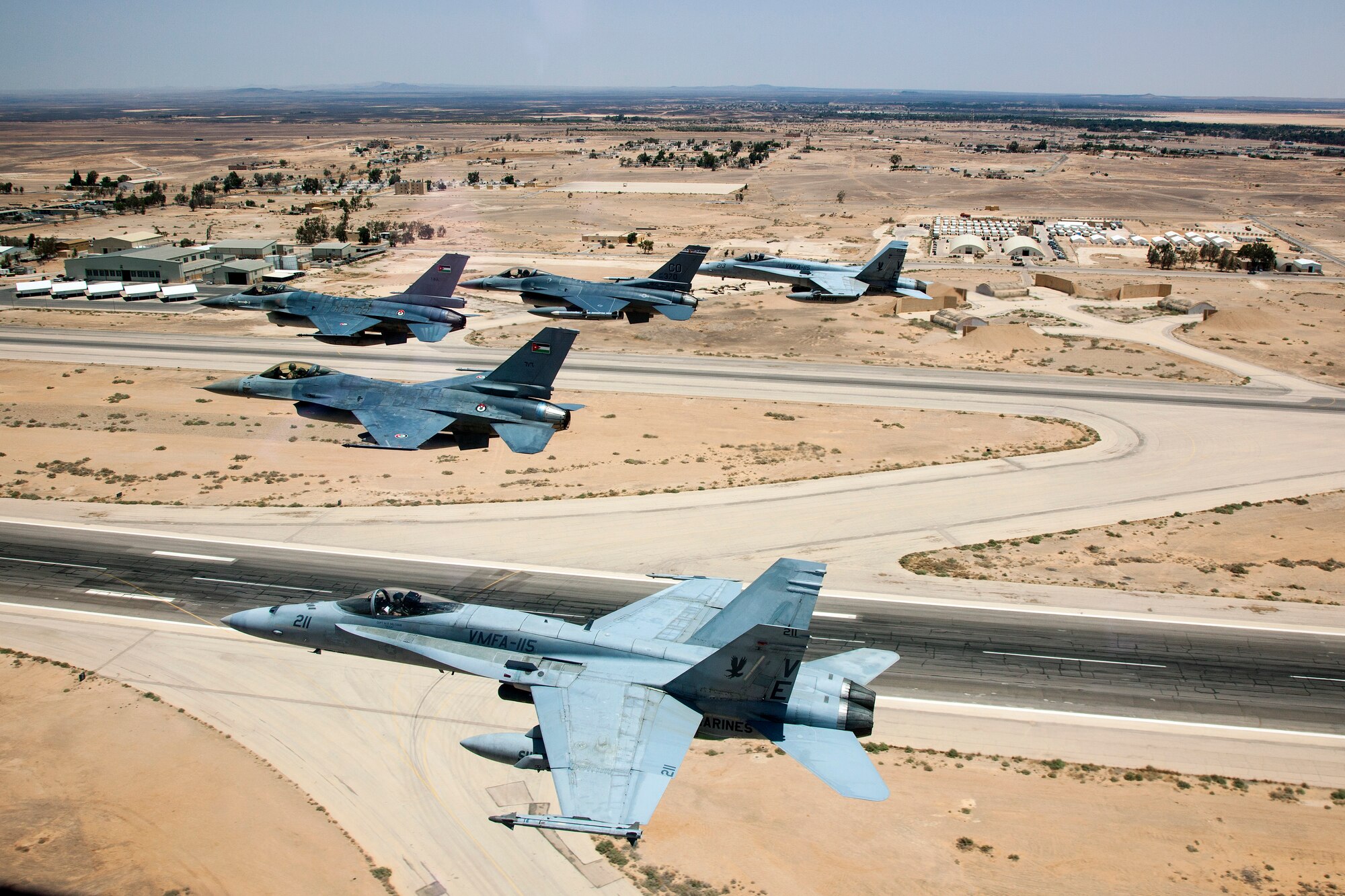 A Jordanian F-16 Fighting Falcon leads another Jordanian F-16, as well as an American F-16 from the120th Fighter Squadron, Colorado Air National Guard, and two Marine F-18's from VMFA-115 over a training base in Northern Jordan. These aircraft represent some of the assets involved in the Eager Lion Exercise being held in Jordan. Eager Lion is a U.S. Central Command-directed, irregular warfare-themed exercise focusing on missions the United States and its coalition partners might perform in support of global contingency operations. (U.S. Air National Guard photo by Senior Master Sgt. John P. Rohrer)