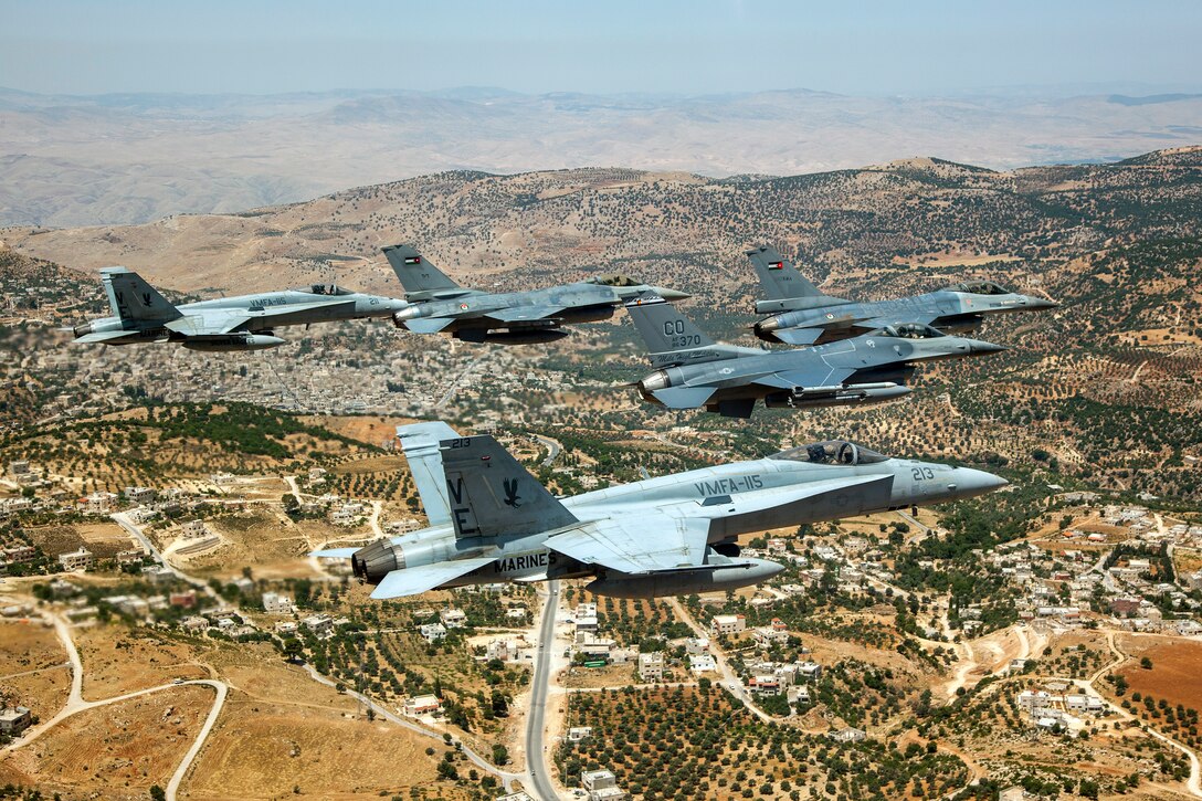 A Jordanian F-16 Fighting Falcon leads another Jordanian F-16, as well as an American F-16 from the120th Fighter Squadron, Colorado Air National Guard, and two Marine F-18's from VMFA-115 over the skies of Jordan. These aircraft represent some of the assets involved in the Eager Lion Exercise being held in Jordan. Eager Lion is a U.S. Central Command-directed, irregular warfare-themed exercise focusing on missions the United States and its coalition partners might perform in support of global contingency operations. (U.S. Air National Guard photo by Senior Master Sgt. John P. Rohrer)