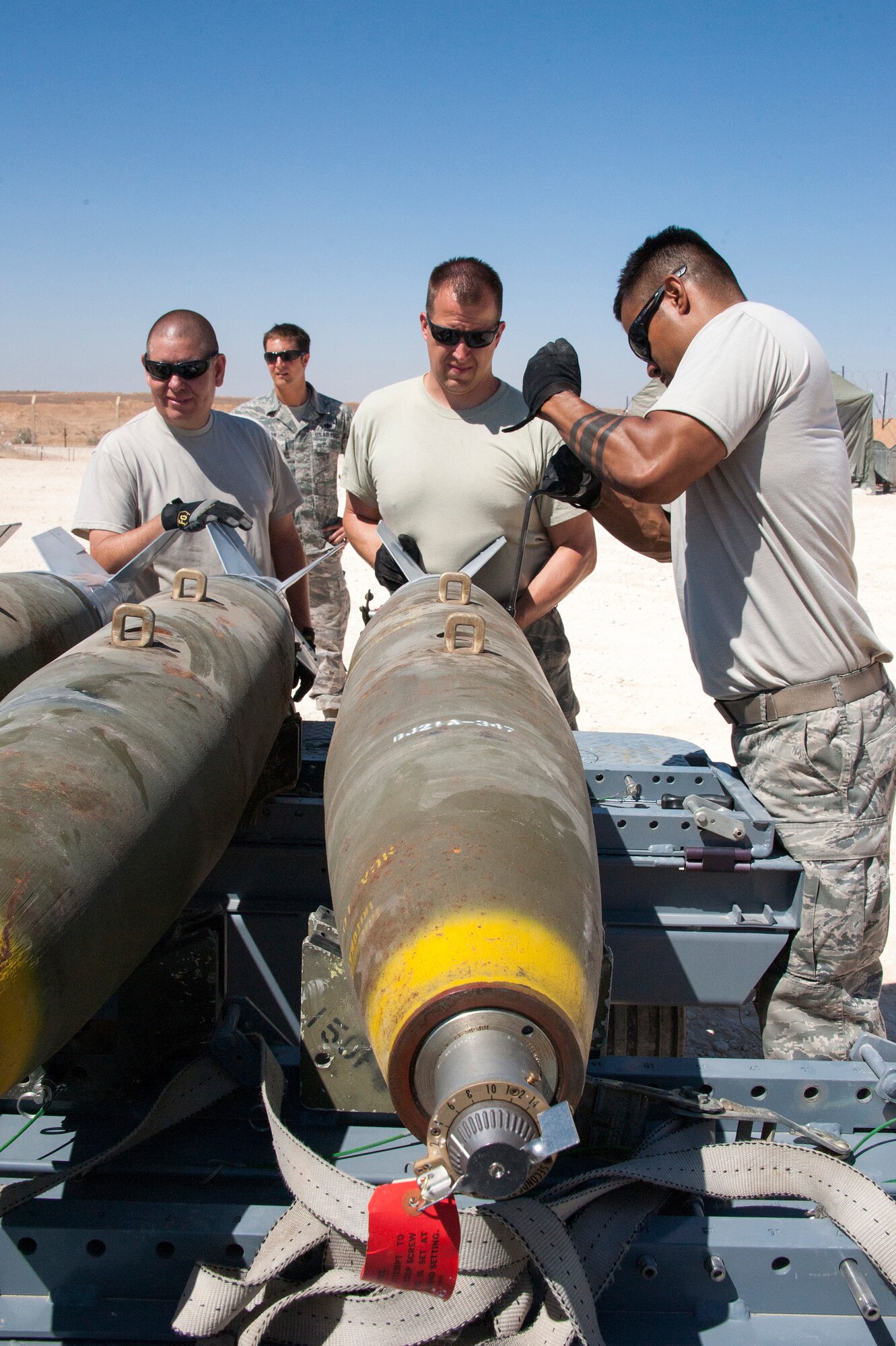 Munitions specialists with the 140th Wing, Colorado Air National Guard, install a tail section on a MK-82 bomb that will be used in a bombing demonstration at a training base in Northern Jordan as part of Exercise Eager Lion. Eager Lion is a U.S. Central Command-directed, irregular warfare-themed exercise focusing on missions the United States and its coalition partners might perform in support of global contingency operations. (U.S. Air National Guard photo by Senior Master Sgt. John P. Rohrer)