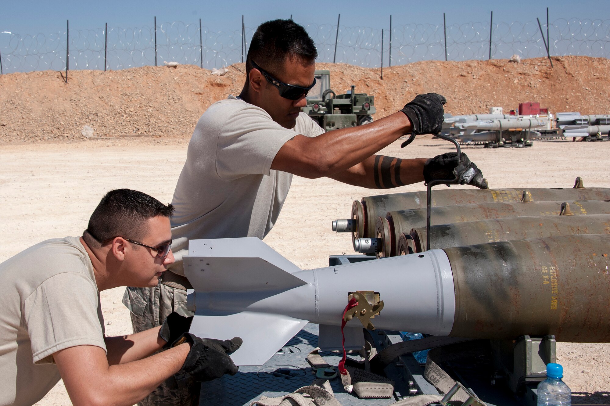 Munitions specialists with the 140th Wing, Colorado Air National Guard, install a fin section on a MK-82 bomb that will be used during a first-run bombing demonstration at a training base in Northern Jordan as part of Exercise Eager Lion. Eager Lion is a U.S. Central Command-directed, irregular warfare-themed exercise focusing on missions the United States and its coalition partners might perform in support of global contingency operations. (U.S. Air National Guard photo by Senior Master Sgt. John P. Rohrer)