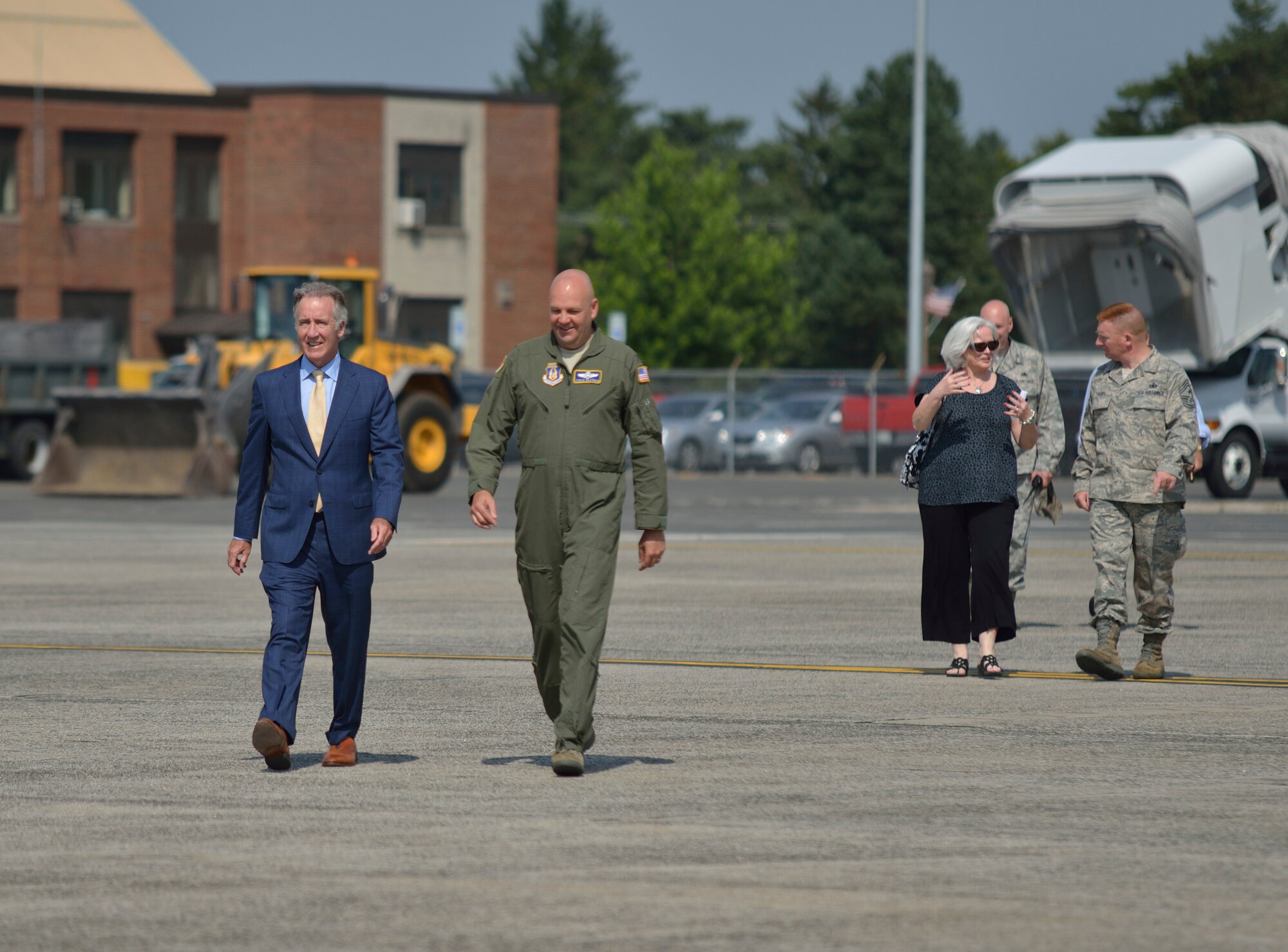 Massachusetts Congressman Richard Neal and Col. Steven Vautrain walk across the Westover Air Reserve Base flightline to join the other 40 civic, business, and military leaders gathered at a ceremony June 24 announcing a $24.4M contract to fund
a new fuel hydrant system on base. 
