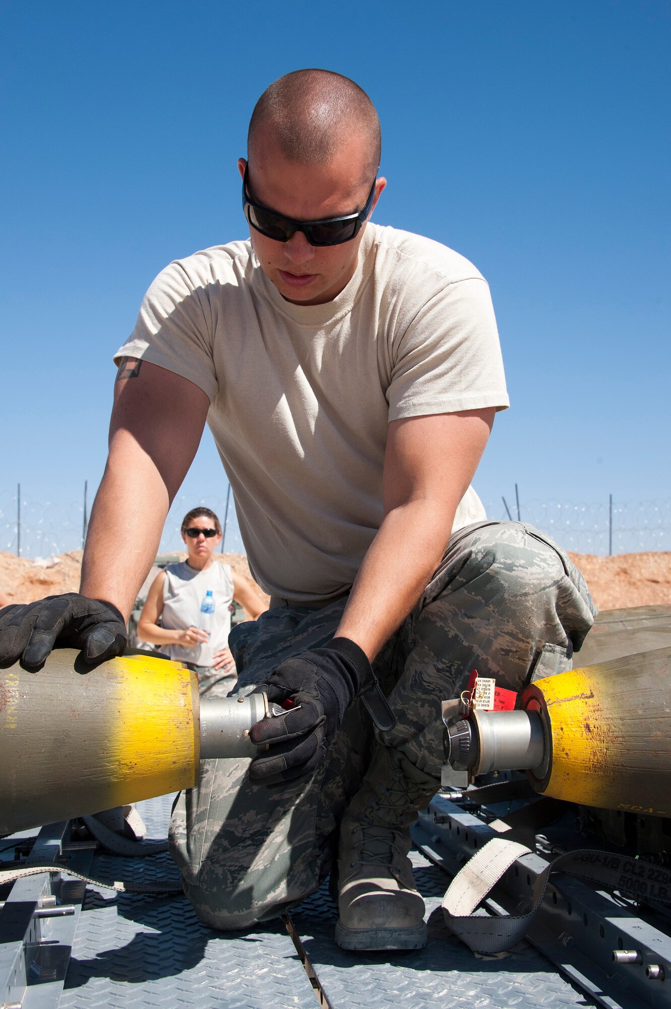 First Lt. Aimee Zick, a 140th Wing maintenance officer, looks on as Senior Airman Dillon Larson, a munitions specialist, both from the Colorado Air National Guard, installs a fuse in a MK-82 bomb that will be used in a bombing demonstration at a training base in Northern Jordan as part of Exercise Eager Lion. Eager Lion is a U.S. Central Command-directed, irregular warfare-themed exercise focusing on missions the United States and its coalition partners might perform in support of global contingency operations. (U.S. Air National Guard photo by Senior Master Sgt. John P. Rohrer)