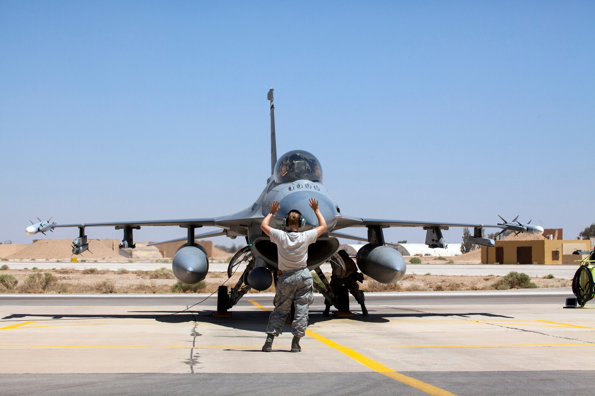Crew chiefs Senior Airman Kristen Lee and Tech Sgt. Joshua Matthews from the 140th Maintenance Squadron, Colorado Air National Guard, ready an F-16 Fighting Falcon for takeoff as part of a scramble competition event between the Colorado Air National Guard and the Royal Jordanian Air Force. The Scramble tests the pilots and their crew chiefs in their ability to launch aircraft in a simulated quick response scenario during Eager Lion. Eager Lion is a U.S. Central Command-directed, irregular warfare-themed exercise focusing on missions the United States and its coalition partners might perform in support of global contingency operations. (U.S. Air National Guard photo by Senior Master Sgt. John P. Rohrer)