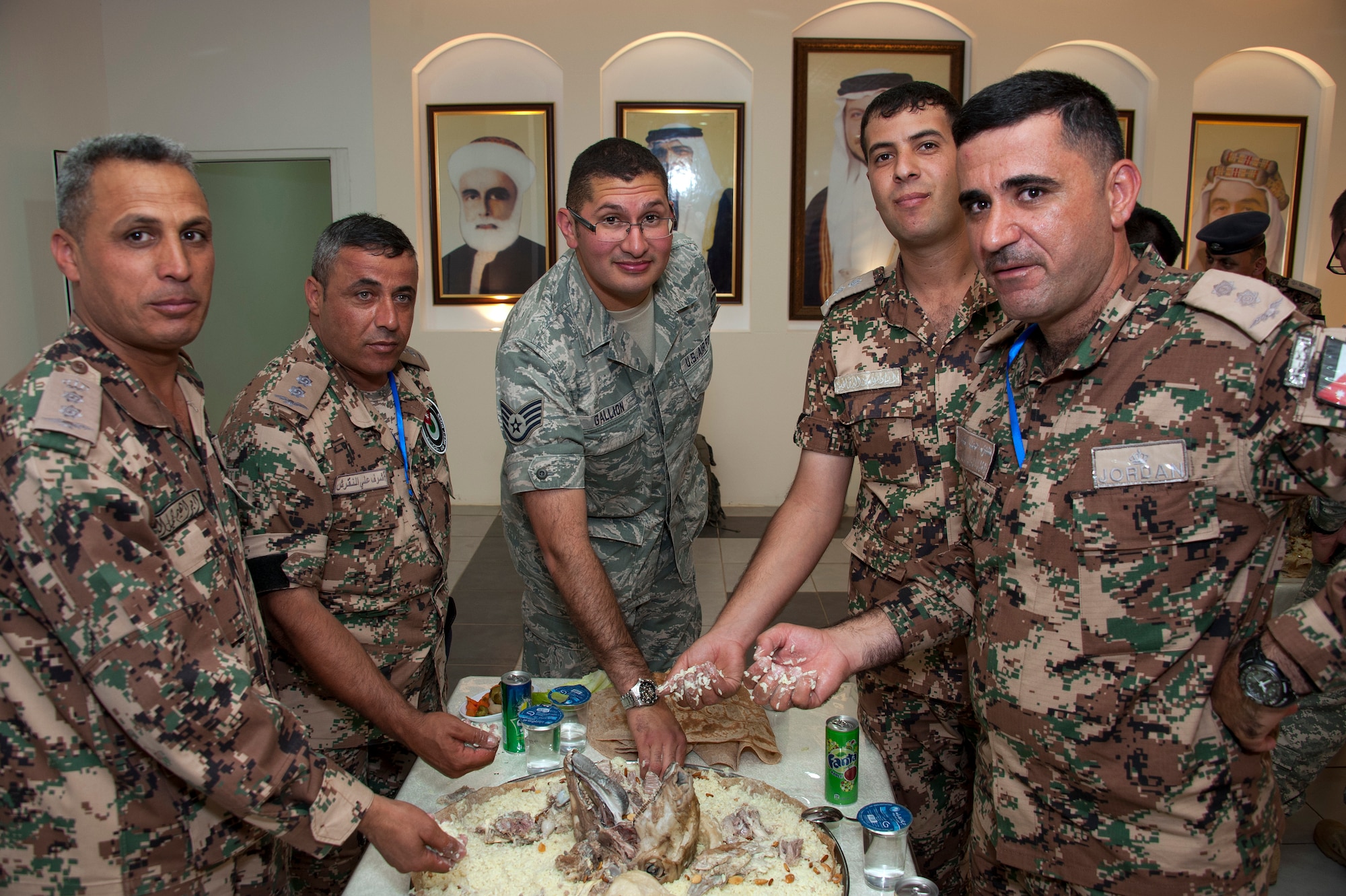 As part of the opening ceremonies of an Eager Lion event, members from the Royal Jordanian Air Force share a traditional meal of mansaf with Staff Sgt. Erik Gallion (pictured) as well as others from the Colorado Air National Guard. Eager Lion is a U.S. Central Command-directed, irregular warfare-themed exercise focusing on missions the United States and its coalition partners might perform in support of global contingency operations. (U.S. Air National Guard photo by Senior Master Sgt. John P. Rohrer)