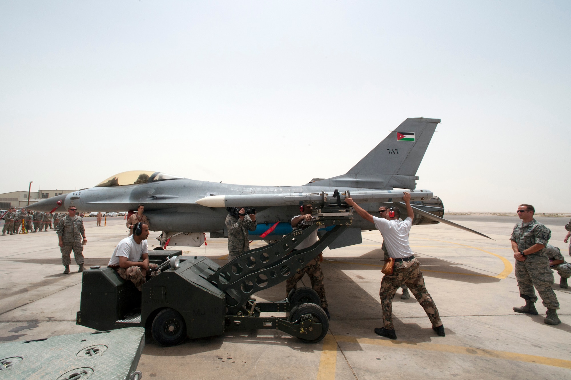During a practice munitions loading competition, the Jordanian Air Forces rush to expediently install an inert AIM 120 Missile on an F-16 Fighting Falcon jet in a friendly competition with their American counterparts from Colorado during the Eager Lion exercise. Eager Lion is a U.S. Central Command-directed, irregular warfare-themed exercise focusing on missions the United States and its coalition partners might perform in support of global contingency operations.  (U.S. Air National Guard photo by Senior Master Sgt. John P. Rohrer)