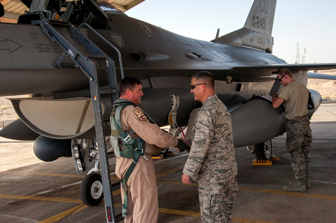 Col. Floyd Dunstan (right) greets Lt. Col. Patrick Hanlon, both from the Colorado Air National Guard, as he arrives at a training base in Northern Jordan as part of the Eager Lion exercise. Eager Lion is a U.S. Central Command-directed, irregular warfare-themed exercise focusing on missions the United States and its coalition partners might perform in support of global contingency operations. (U.S. Air National Guard photo by Senior Master Sgt. John P. Rohrer)