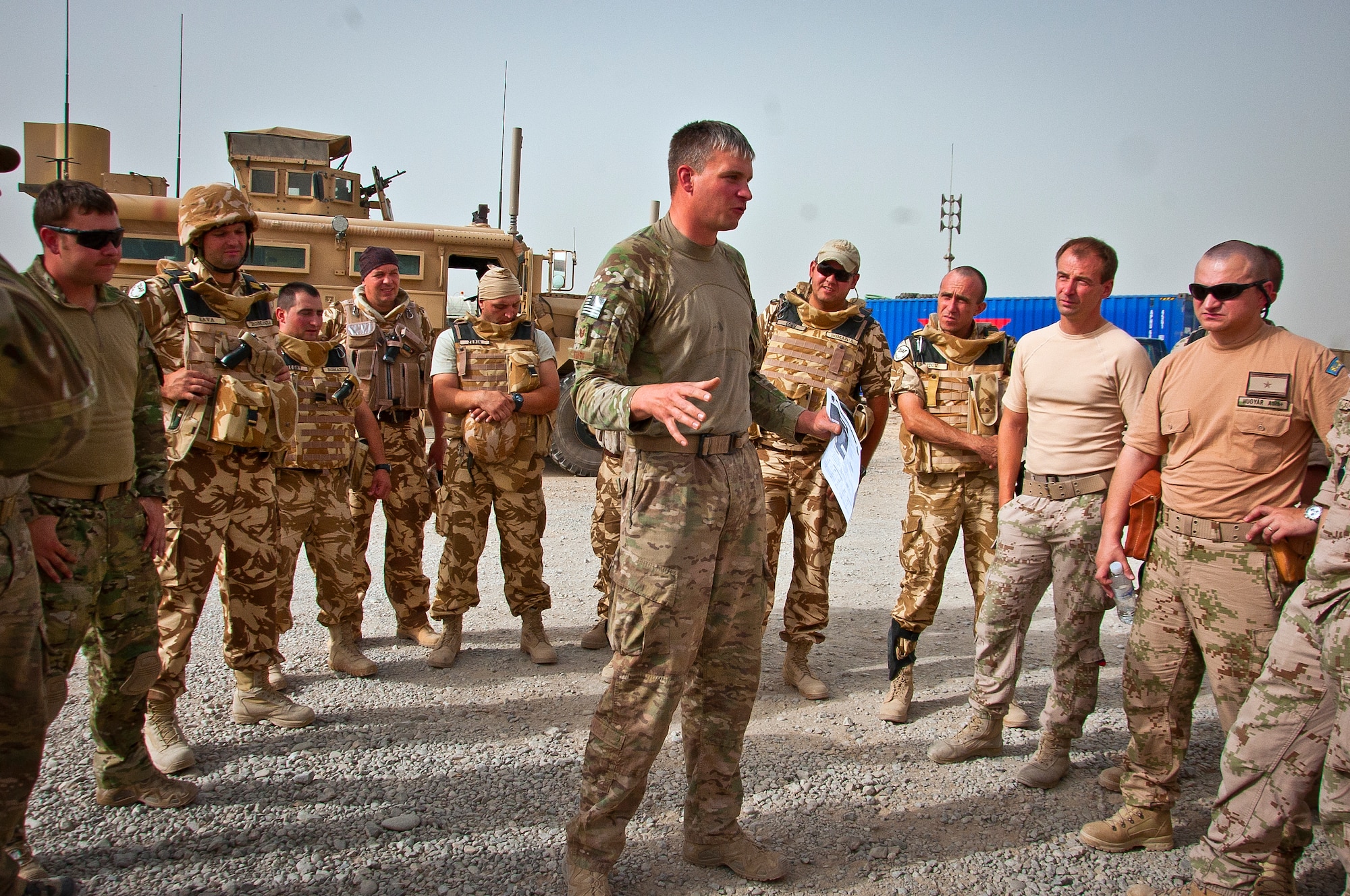 U.S. Air Force Tech. Sgt. Matthew Stark, 466th Air Expeditionary Squadron Explosive Ordnance Disposal technician, gives a mission brief to joint-coalition forces June 12, 2013, near Kandahar Airfield, Afghanistan. U.S. Air Force, U.S. Army, Slovakian and Australian EOD personnel participated in the joint mission to dispose of excess military ordnance. Stark, an Amherst, N.Y., native, is deployed from Dyess Air Force Base, Texas. (U.S. Air Force photo/Senior Airman Scott Saldukas)