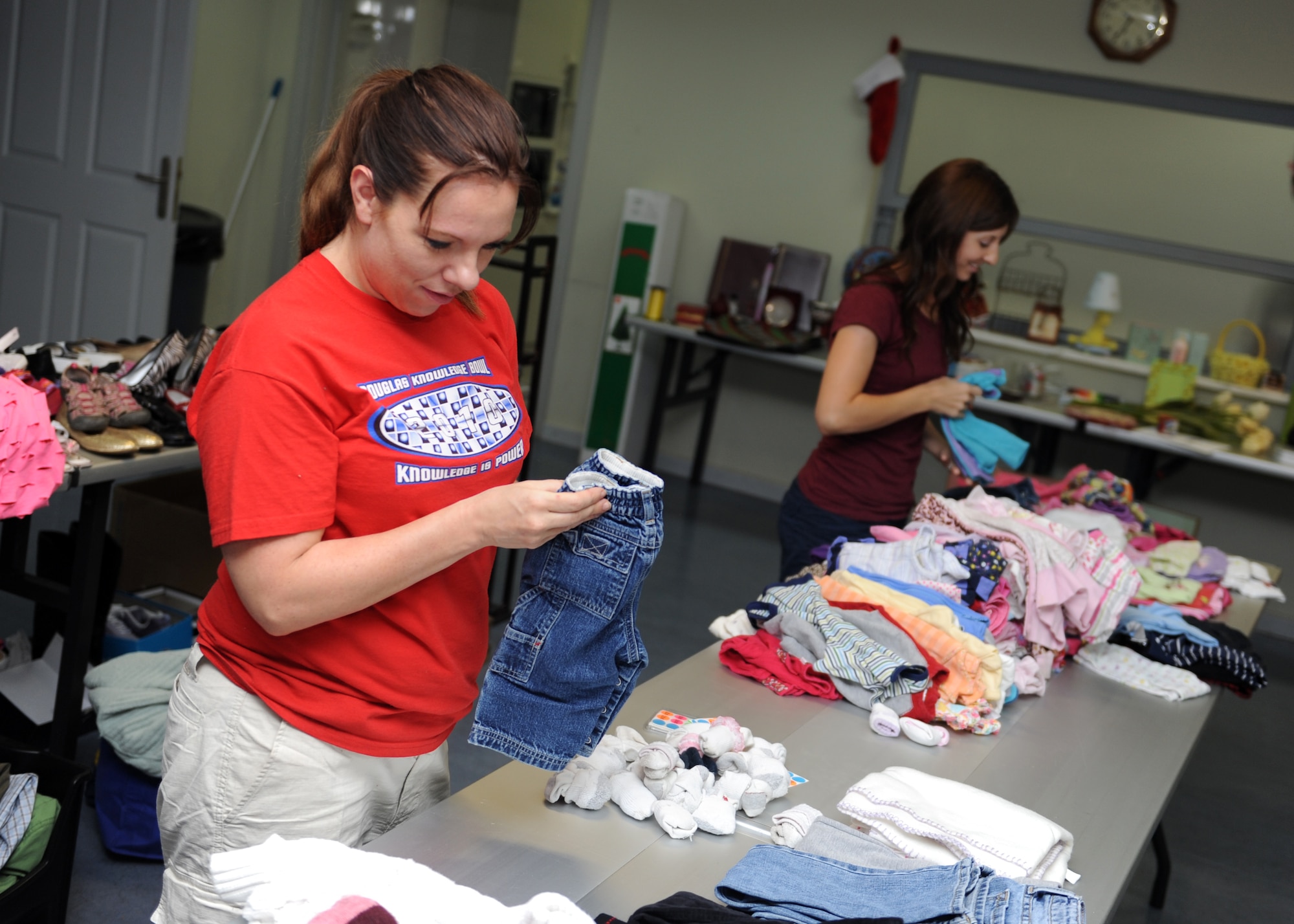 Tech. Sgt. Misty Maturano, 39th Mission Support Group resource advisor folds donated clothes in preparation for the Rummage for Relief fundraiser June 7, 2013 at Incirlik Air Base, Turkey. More than 12 volunteers set up, ran, and cleaned up the sale which raised $2,700 for tornado survivors. (U.S. Air Force photo by Senior Airman Chase Hedrick/Released)