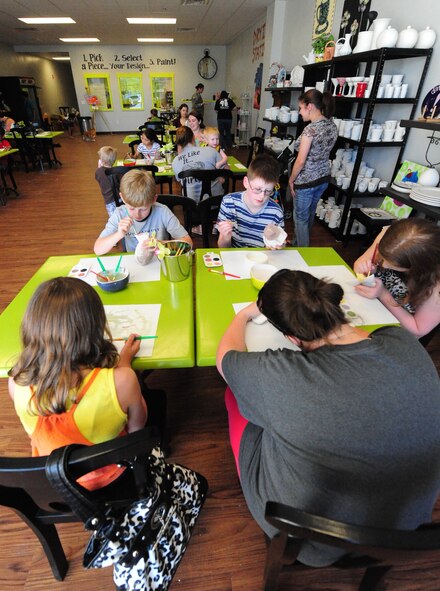 Airmen and dependents paint pottery during a Hearts Apart event at the Chartreuse Moose in Warrensburg, Mo., June 17, 2013. Sponsored by the Airman & Family Readiness Center, the Hearts Apart program provides an opportunity for military dependents to participate in various activities and connect with other individuals who are going through similar situations. (U.S. Air Force photo by Staff Sgt. Nick Wilson/Released) 
