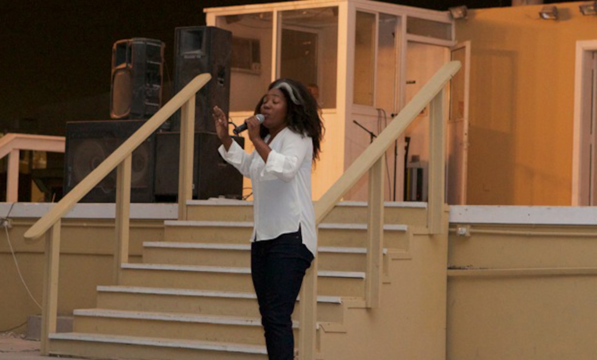 Jessica Tucker performs for the wing’s talent show in Memorial Plaza at the 379th Air Expeditionary Wing in Southwest Asia, June 22, 2013. Tucker was the show’s winner and a 379th Expeditionary Contracting Squadron contract administrator. Service members from across the wing came out to show support for the wing’s talent shows throughout the month of June culminating in the show finale June 22. (Courtesy photo)