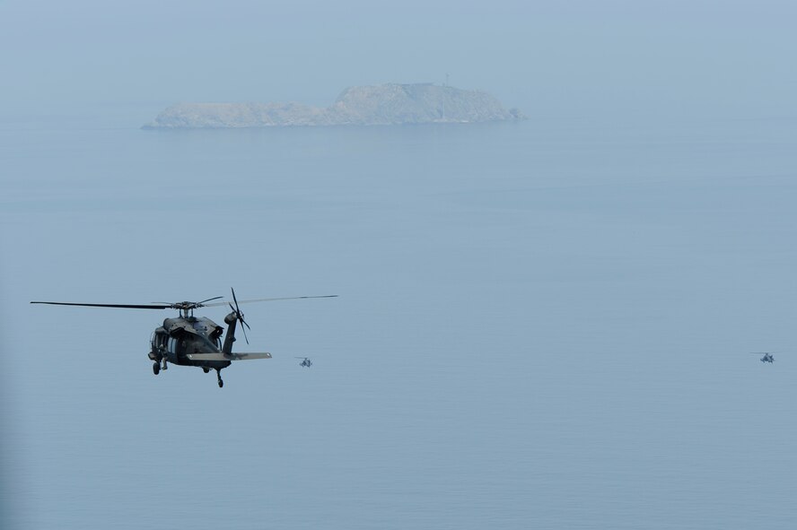 A U.S. Army UH-60 Black Hawk helicopter trails a pair of AH-64 Apache Longbow helicopters during a live-fire exercise at Jik-Do Island, Republic of Korea, June 7, 2013. The helicopters were assigned to the 4th Aerial Reconnaissance Battalion (Attack), 2nd Aviation Regiment, Camp Humphreys, ROK and staged out of Kunsan Air Base, ROK during their annual training. (U.S. Air Force photo/ Staff Sgt. Tong Duong/ Released)