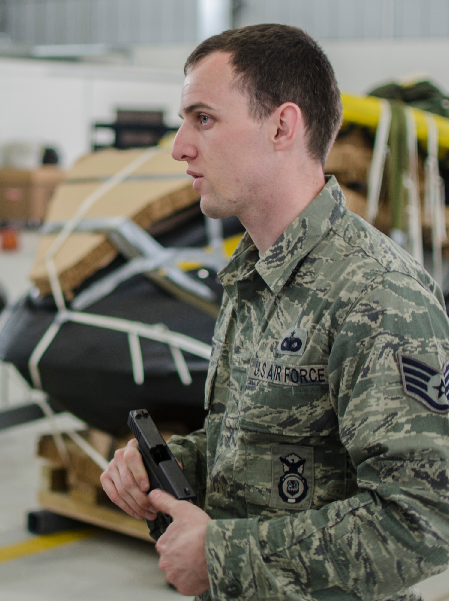 Staff Sgt. Jacob Spencer, 321st Special Tactics Squadron combat arms training and maintenance technician, speaks to local civic leaders about 352nd Special Operations Group weapons during a civic leader visit June 21, 2013, on RAF Mildenhall, England. More than 60 community leaders, landowners and other distinguished visitors attended a joint 100th Air Refueling Wing and 352nd Special Operations Group civic leader event focused on showcasing the 352nd SOG and its ongoing expansion. (U.S. Air Force photo by Staff Sgt. Stephen Linch/Released)