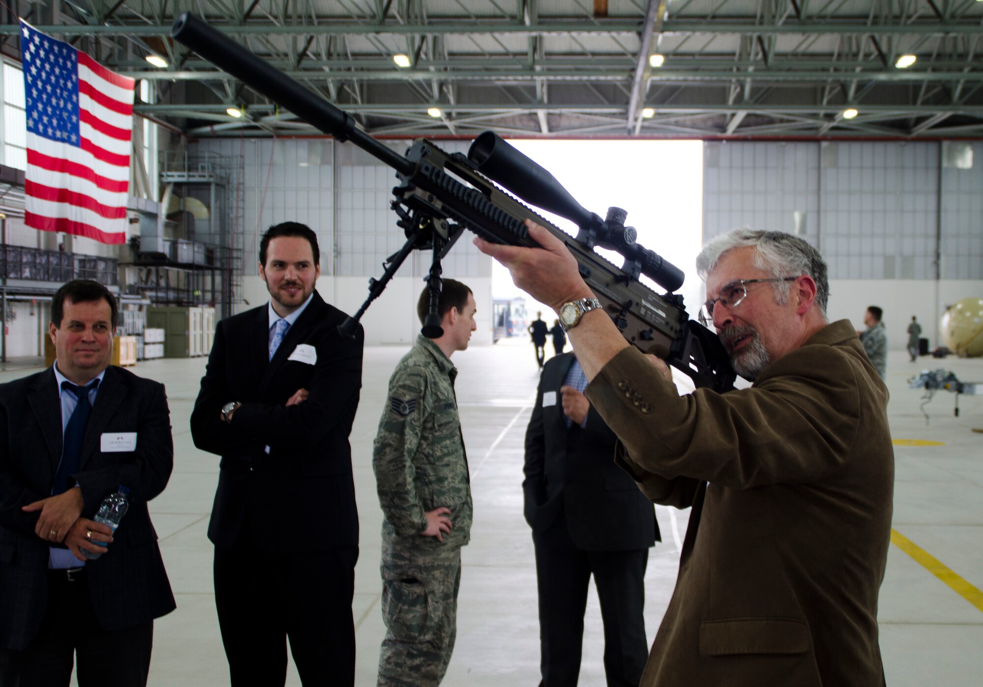 Retired Royal Air Force Air Commodore Bruce Wynn, 100th Communications Squadron honorary commander, looks down the sights of a MK-20 sniper rifle during a civic leader visit June 21, 2013, on RAF Mildenhall, England. More than 60 community leaders, landowners and other distinguished visitors attended a joint 100th Air Refueling Wing and 352nd Special Operations Group civic leader event focused on showcasing the 352nd SOG and its ongoing expansion. (U.S. Air Force photo by Staff Sgt. Stephen Linch/Released)