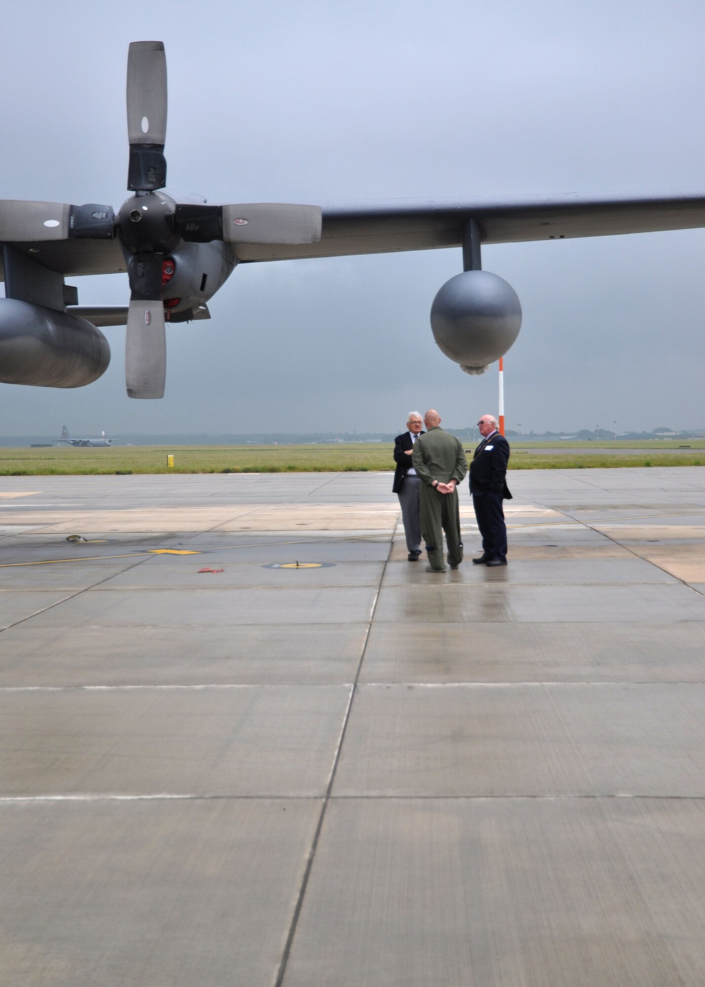 Center, Maj. David Jeltema, 352nd Special Operations Group executive officer, interacts with two distinguished visitors under the wing of an MC-130P Combat Shadow during a civic leader visit June 21, 2013, on RAF Mildenhall, England. More than 60 community leaders, landowners and other distinguished visitors attended a joint 100th Air Refueling Wing and 352nd SOG civic leader event focused on showcasing the 352nd SOG and discussing its ongoing expansion. (U.S. Air Force photo by Capt. Jason Smith/Released)