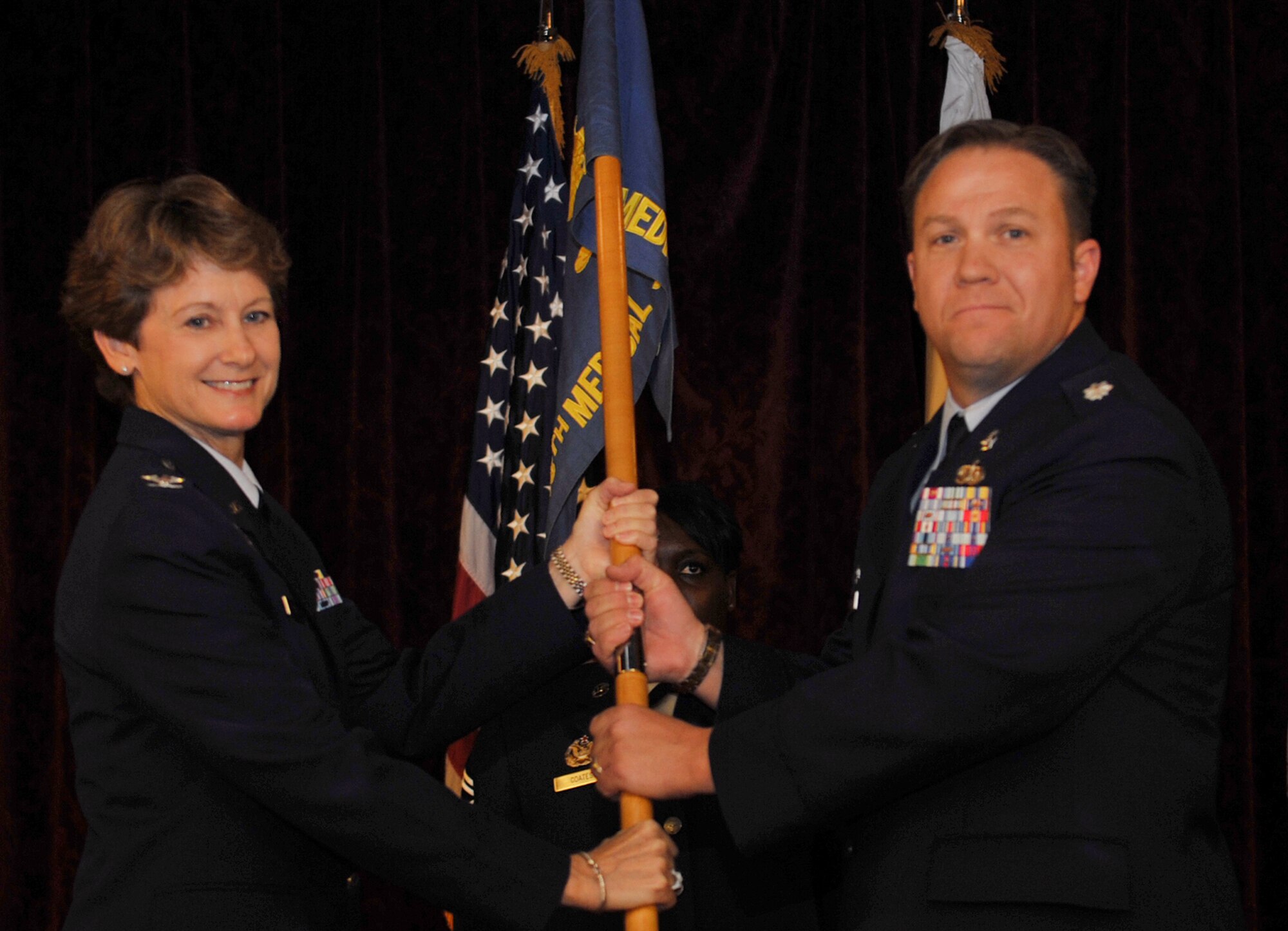 U.S. Air Force Lt. Col. Jay Veeder, 18th Medical Support Squadron commander, accepts the guidon from Col. Barbara King, 18th Medical Group commander, during the 18th MDSS change of command ceremony at the Rocker NCO Club on Kadena Air Base, Japan, June 25, 2013. Before Veeder arrived to Kadena, he served as a medical service corps officer, 559th Medical Group, Lackland Air Force Base, Texas. (U.S. Air Force photo by Naoto Anazawa/Released)