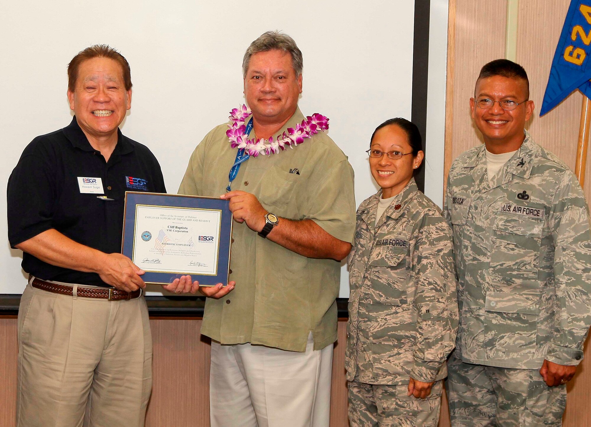 From left, retired Army Lt. Col. Howard Sugai, the military outreach coordinator for the Employer Support of the Guard and Reserve, presents a Patriot Award to Cliff Baptista, a program manager and Pacific Air Forces site leader for VSE Corporation, joined by his employee, Maj. Kathleen M. Izon, the commander of the 48th Aerial Port Squadron, and the commander of the 624th Regional Support Group, Col. Maynard "Max" Mendoza. ESGR has served the military for more than 40 years, fostering a culture in which all employers support and value the employment and military service of members of the National Guard and Reserve in the United States.  (U.S. Air Force photo by Staff Sgt. Rashard Coaxum)