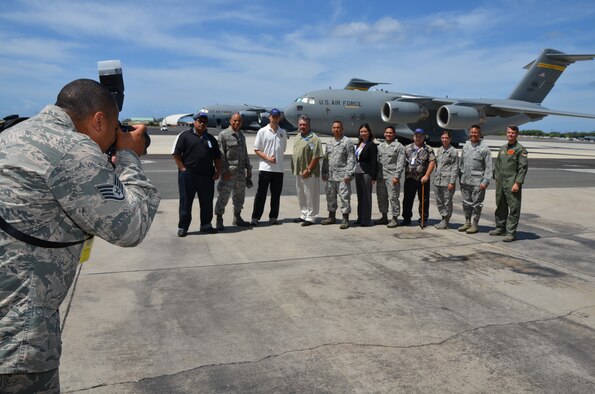 Civilian employers pose for a photo with 624th Regional Support Group reservists in front of a C-17 Globemaster at an Employer Support for the Guard and Reserve event at Joint Base Pearl Harbor-Hickam, Hawaii, June 8, 2013. The commander of the 624th RSG, Col. Maynard "Max" Mendoza, far right, hosted a tour of the unit's three Hawaii-based squadrons to give employers a close-up view of what their reservists do one weekend a month. (U.S. Air Force photo by Tech. Sgt. Phyllis E. Keith)