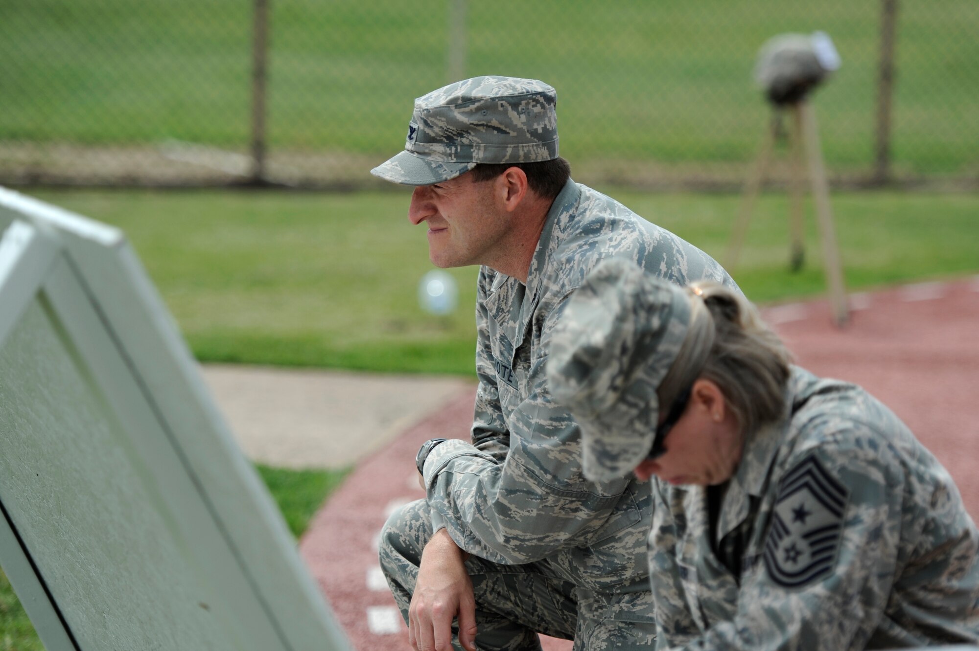 KUNSAN AIR BASE, Republic of Korea – Colonel S. Clinton Hinote, 8th Fighter Wing commander, and Chief Master Sgt. Rhonda Miller, 8th FW command chief, observe a moment of silence for victims of sexual assault at the fitness center track, June 21, 2013. A message board was set up so Wolf Pack members could leave a note to both victims depicted or others affected by sexual assault. (U.S. Air Force photo by Staff Sgt. Tong Duong)