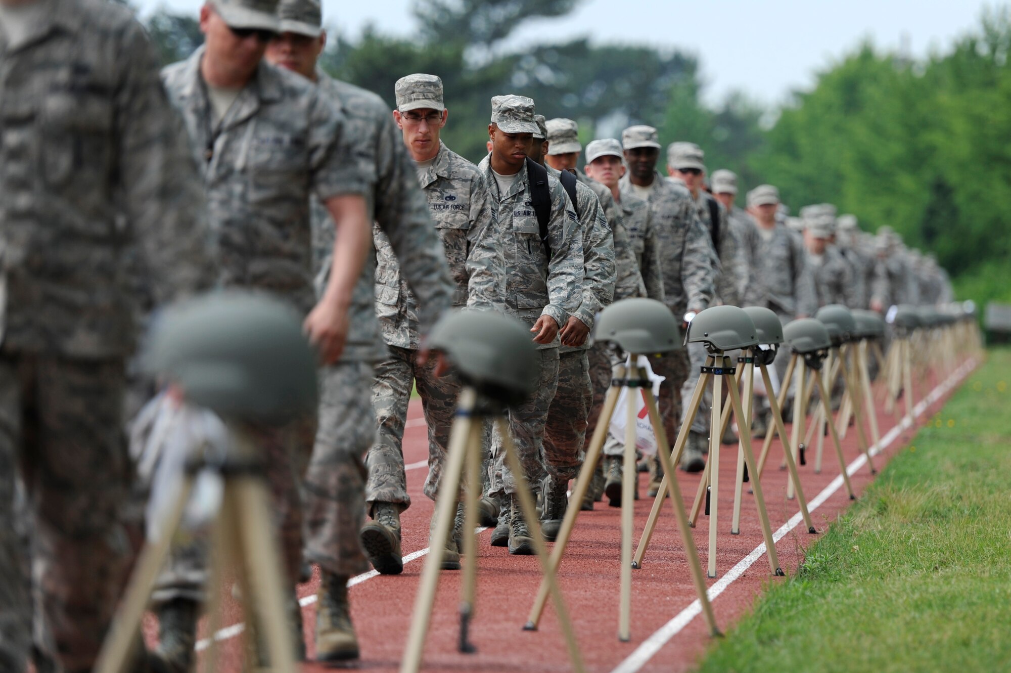 KUNSAN AIR BASE, Republic of Korea – Members of the 8th Maintenance Squadron observe a ‘silent walk’ memorial display at the fitness center track, June 21, 2013. Prior to the event, Col. S. Clinton Hinote, 8th Fighter Wing commander, briefed the wing on sexual assault statistics and a recent survey taken at the Wolf Pack. (U.S. Air Force photo by Staff Sgt. Tong Duong)