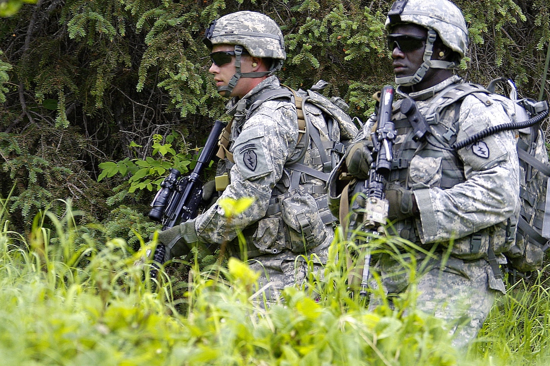 Army Pfc. Travis Watson, left, and Spc. Alfred Angelo move to their next positions during a dismounted live-fire exercise at the Infantry Platoon Battle Course on Joint Base Elmendorf-Richardson, Alaska, June 19, 2013. Watson and Angelo are assigned to 1st Squadron, Airborne, 40th Cavalry Regiment. Soldiers traversed the 250-meter course in teams, reacting and attacking, resupplying and reporting casualties.
