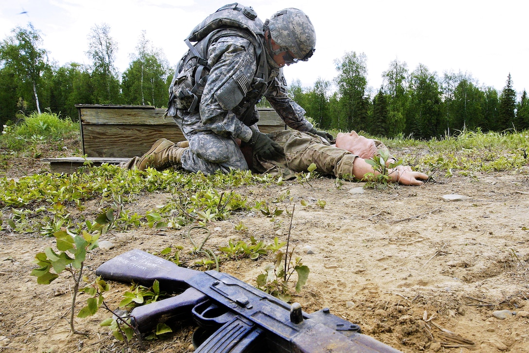 Army Pfc. Andrey Selivanov conducts a search of a mock enemy combatant during a dismounted live-fire exercise at the Infantry Platoon Battle Course on Joint Base Elmendorf-Richardson, Alaska, June 19, 2013. Selivanov is assigned to 1st Squadron, Airborne, 40th Cavalry Regiment.
