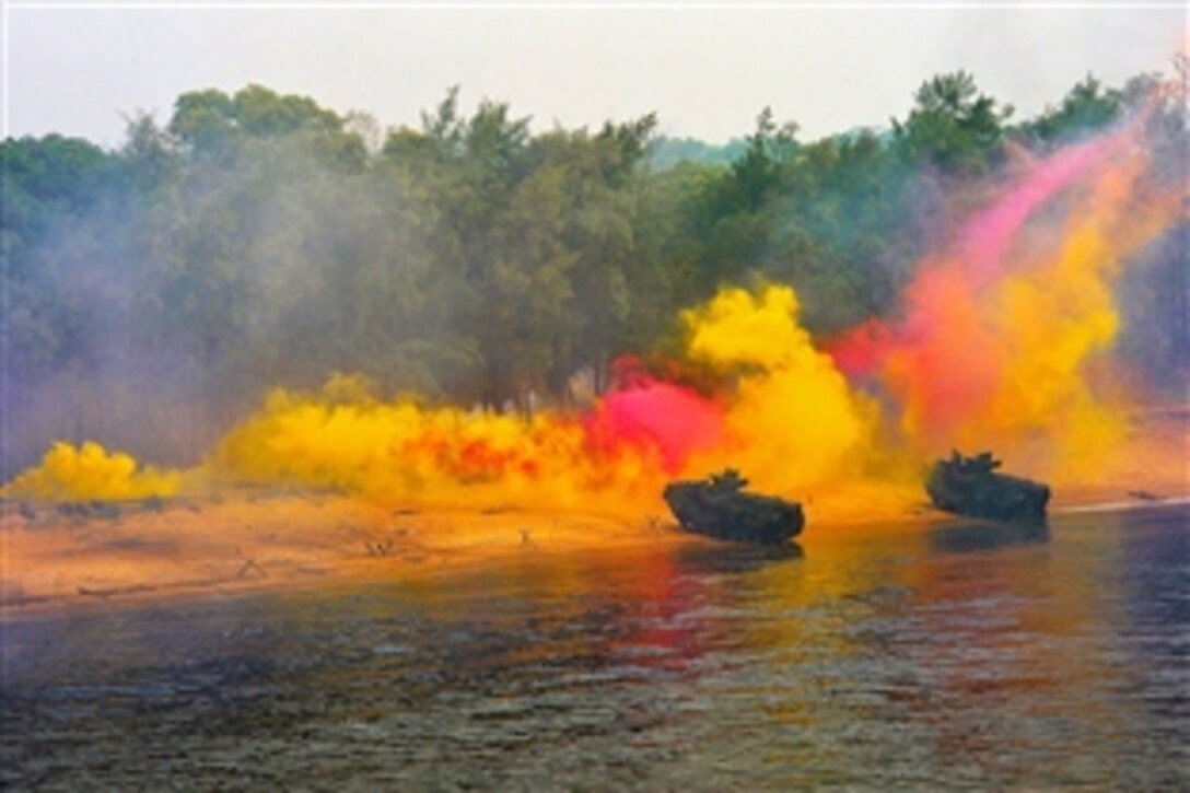 U.S. Marines from the USS Tortuga use amphibious assault vehicles, smoke flares and explosives for an amphibious assault during Cooperation Afloat Readiness and Training 2013 off the coast of Malaysia, June 21, 2013. CARAT is a series of bilateral military exercises between the U.S. Navy and the armed forces of Bangladesh, Brunei, Cambodia, Indonesia, Malaysia, the Philippines, Singapore, Thailand and Timore-Leste.