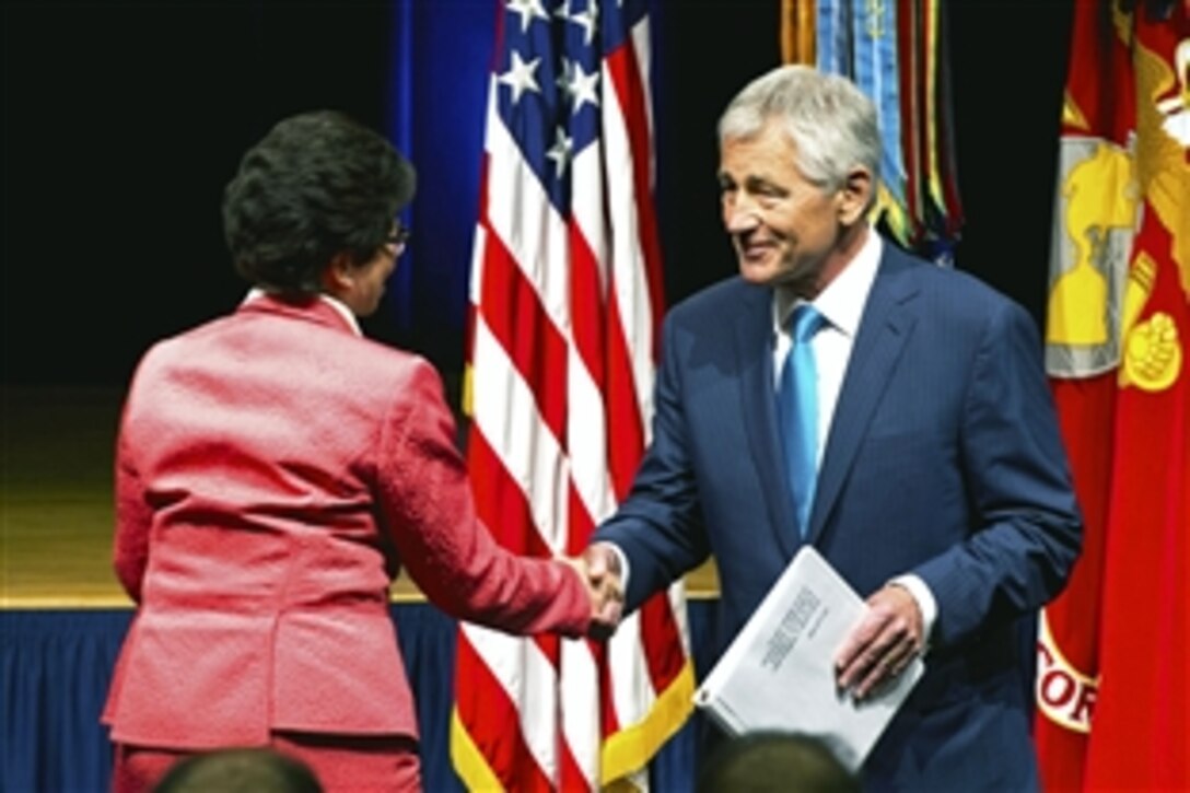 Defense Secretary Chuck Hagel shakes hands with Valerie Jarrett, senior advisor to President Barack Obama, after introducing her at a Lesbian, Gay, Bisexual, Transgender Pride Month event at the Pentagon, June 25, 2013.