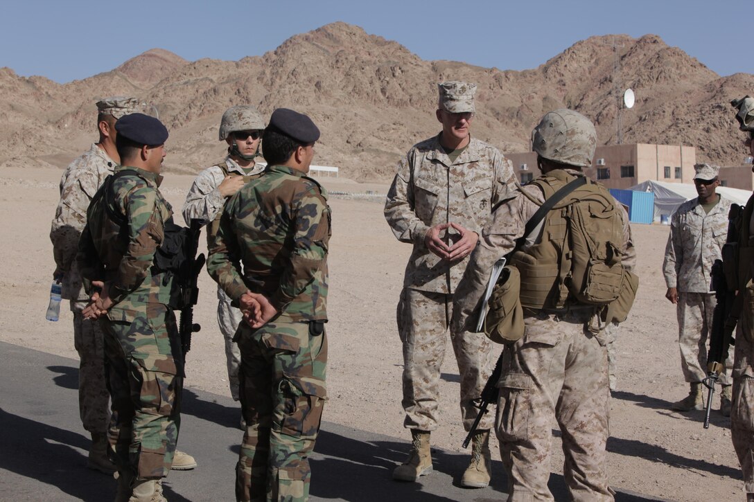 Brig. Gen. Gregg Olson, the commanding general of Marine Corps Forces Central Command (Forward), speaks with U.S. and Jordanian Marines about security protocols and training progress during Exercise Eager Lion at Camp Titin, Jordan, June 13, 2013.