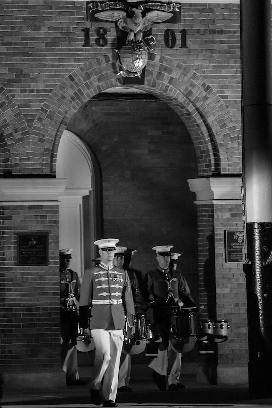 Chief Warrant Officer James D. Foley, U.S. Marine Drum & Bugle Corps assistant director, leads the unit on to the parade deck during a Friday Evening Parade at Marine Barracks Washington, D.C., June 21. 