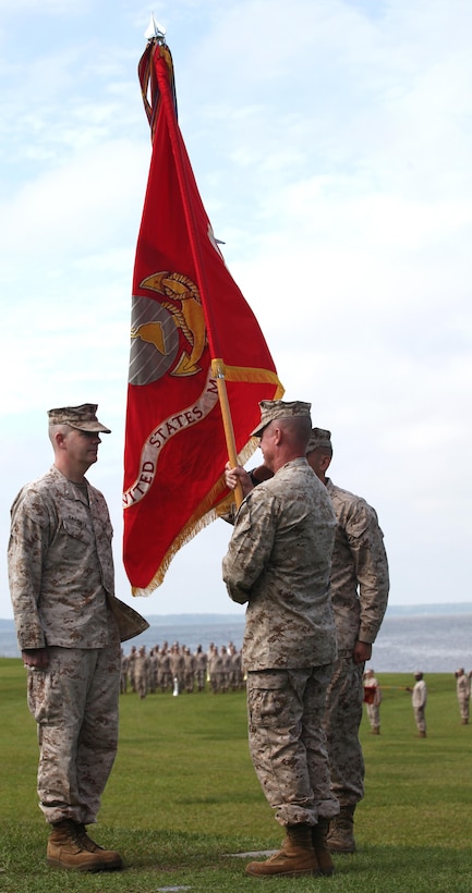 Lt. Col. David G. Bardorf passes the colors to  Lt. Col. Harry L. Gardner, symbolizing the passing of command from the outgoing commanding officer to the incoming aboard Marine Corps Base Camp Lejeune June 21.Bardorf is heading to the Marine Corps War College for a year of training.