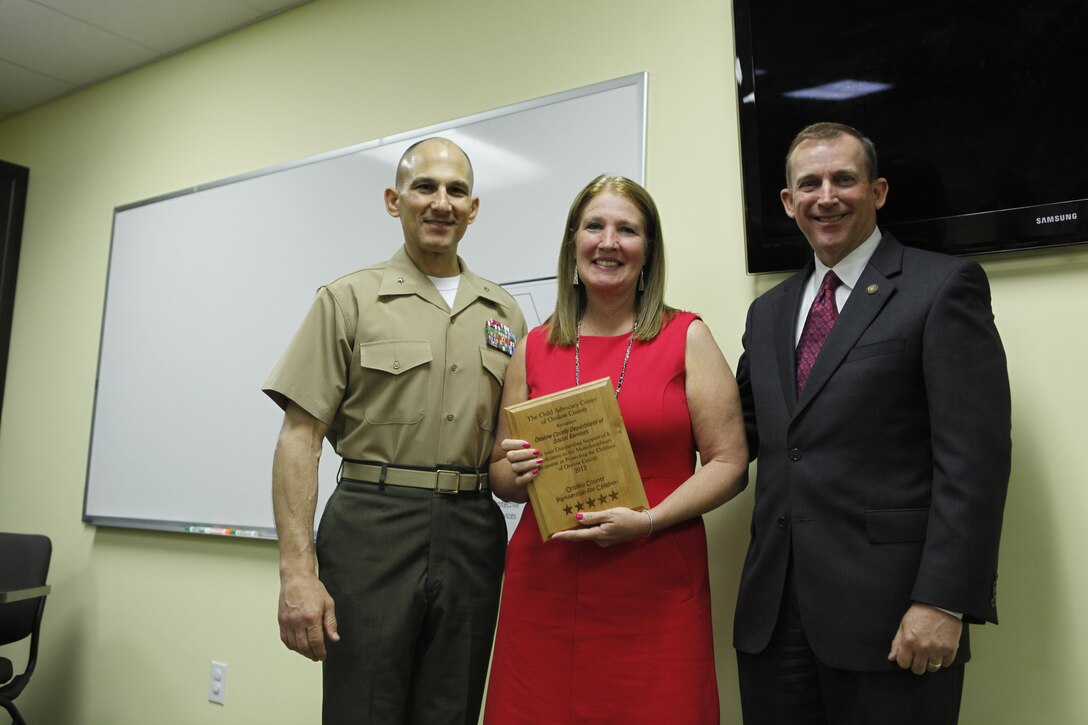 A representative from the Onslow County Department of Social Services was presented with a plaque by Brig. Gen. Thomas A. Gorry, the commanding general of Marine Corps Base Camp Lejeune and North Carolina Senator Harry Brown during a ceremony hosted by the Child Advocacy Center of Onslow County recently. The plaque commemorated the departments commitment to protecting the children of Onslow County. 

