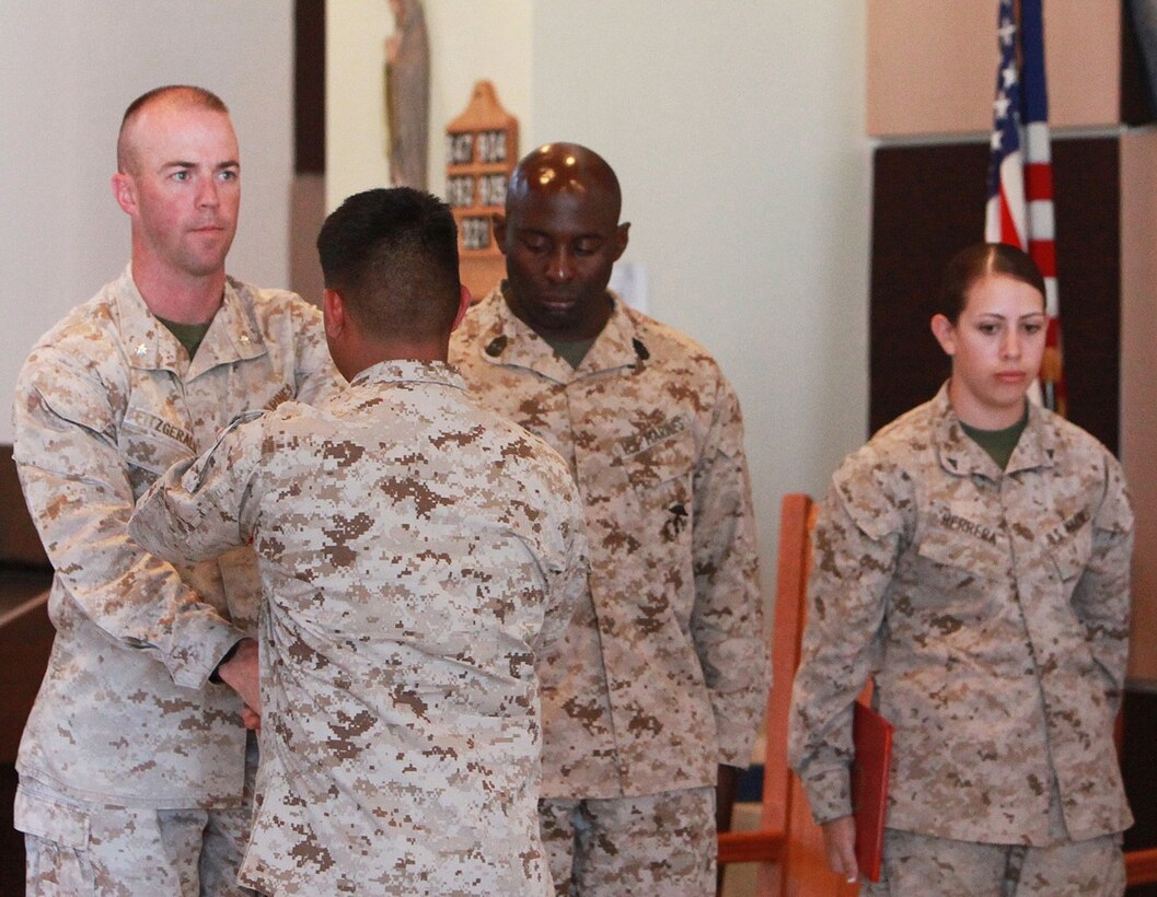 Lieutenant Col. Michael J. Fitzgerald, left, commanding officer, 1st Supply Battalion, Combat Logistics Regiment 15, 1st Marine 
Logistics Group, hands a certificate of appreciation to a Marine with 1st Supply Bn. during a capstone ceremony aboard Camp 
Pendleton, Calif., May 23, 2013. The Marines were recognized for their honorable service to the Marine Corps.