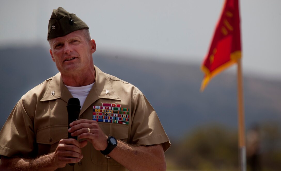 Colonel Roger B. Turner, the outgoing commanding officer of 5th Marine Regiment, thanks his Marines and sailors during a change of command ceremony at the Camp San Mateo helicopter landing pad here, June 25, 2013. Turner, a native of Laurel, Md., relinquished his command of the regiment to Col. Jason Q. Bohm, the incoming commanding officer and native of Oyster Bay, N.Y. Turner will assume his post as the new Military Secretary for the Commandant of the Marine Corps.