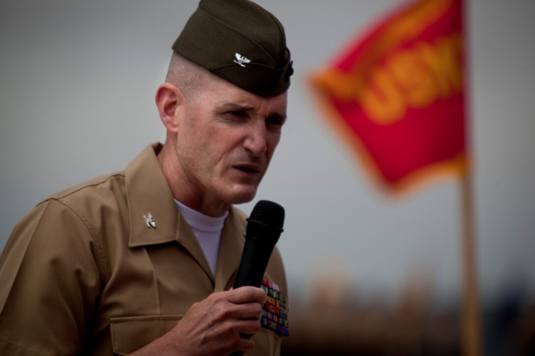 Colonel Jason Q. Bohm, the incoming commanding officer of 5th Marine Regiment, talks to Marines and sailors serving with the regiment, during a change of command ceremony at the Camp San Mateo helicopter landing pad here, June 25, 2013. Bohm, a native of Oyster Bay, N.Y., took command of the regiment from Col. Roger B. Turner, a native of Laurel, Md.