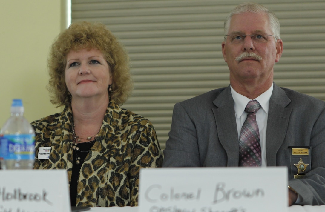 Kathleen Holbrook, the director of the Child Advocacy Center of Onslow County and Col. Boyd L. Brown with the Onslow County Sheriff's Office listen to question during a panel at a recent Domestic Violence Summit. The summit gathered leaders from law enforcement, mental health, victim advocacy programs and others to speak at the event