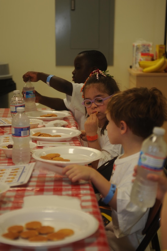 Children eat a snack during a program hosted by the Exceptional Family Member Program at the Quantico Youth Center aboard Marine Corps Base Quantico on June 26, 2013. In addition to the snack, the program offered arts and crafts and a firefighter demonstration given by the Quantico Fire Department.