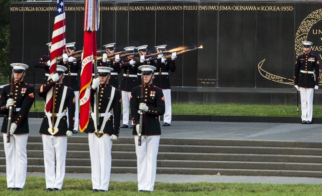 A ceremonial firing party fires a 3-shot volley in honor of the fallen during a Tuesday Sunset Parade at the Marine Corps War Memorial in Arlington, Va., June 25. 