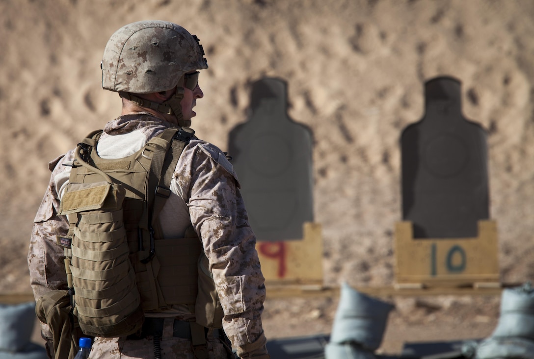 U.S. Marine Corps Capt. James Marek, an advisor assigned to the Afghan National Civil Order Police Kandak 1, observes his targets during a live fire shooting package on Camp Leatherneck, Helmand province, Afghanistan, June 8, 2013. The Marines conducted the training to prepare them for situations they may encounter while conducting missions in support of Operation Enduring Freedom. (U.S. Marine Corps photo by Staff Sgt. Ezekiel R. Kitandwe/Released)