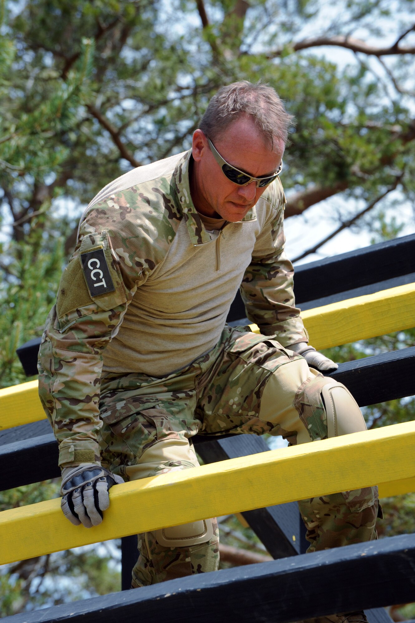 Air National Guard Capt. Scot Berg, 125th Special Tactics Squadron makes his way over an obstacle during the 'Monster Mash' training exercise, June 22, 2013 at Camp Rilea, Ore. The training was held over a five-day period in which the Combat Operations Group (COG) made up of four individual Oregon Air Guard units; 125th STS, 116th ACS, 270th ATCS and the 123rd WF. The focus of the training was to build unit morale, establish new professional networks and enhance military development. (Air National Guard photo by Tech. Sgt. John Hughel, 142nd Fighter Wing Public Affairs)