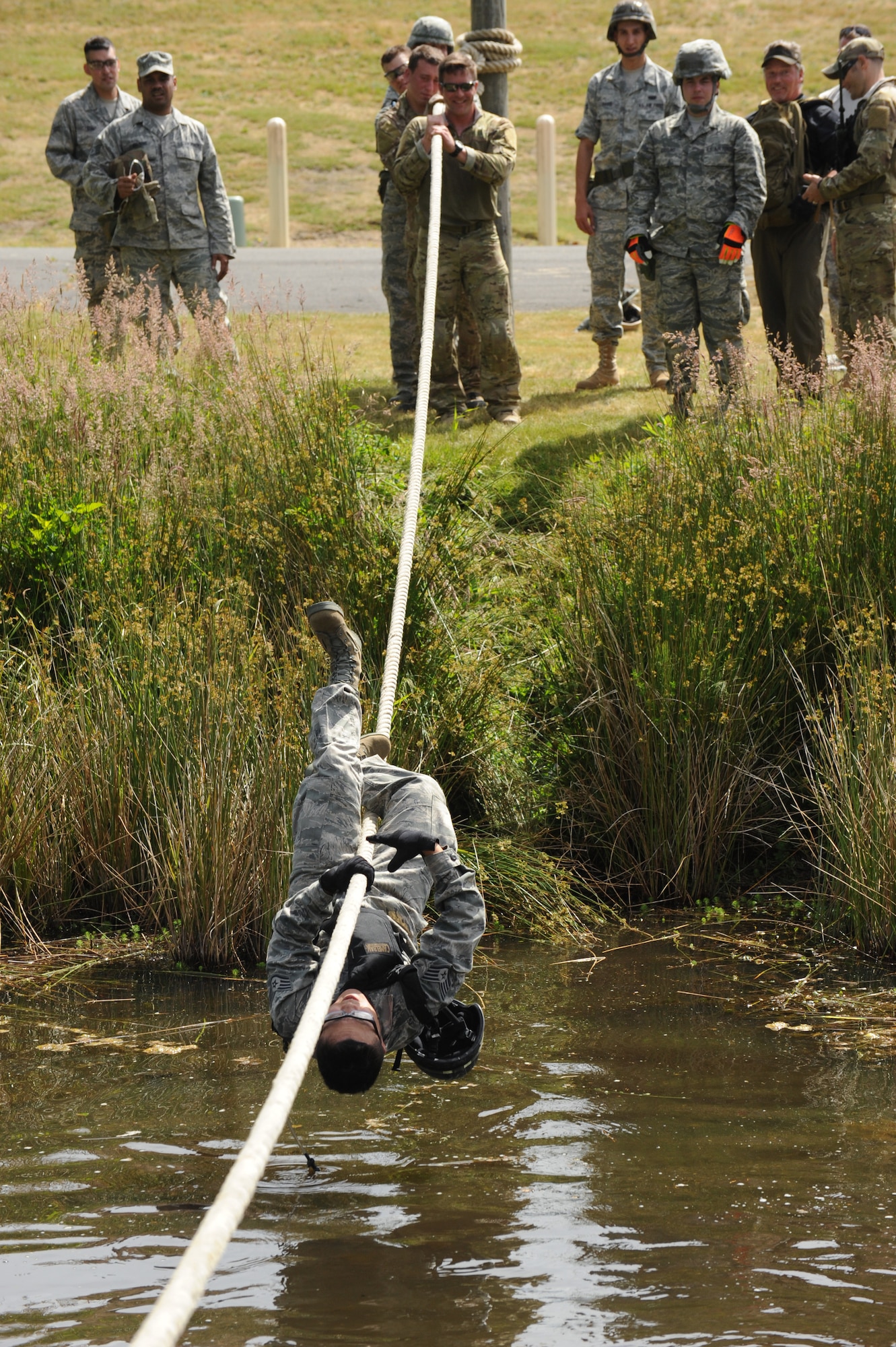 Airmen of the Oregon Combat Operations Group work together during the 'Monster Mash' training exercise, June 22, 2013 at Camp Rilea, Ore. The training was held over a five-day period in which the Combat Operations Group (COG) made up of four individual Oregon Air Guard units; 125th STS, 116th ACS, 270th ATCS and the 123rd WF. The focus of the training was to build unit morale, establish new professional networks and enhance military development. (Air National Guard photo by Tech. Sgt. John Hughel, 142nd Fighter Wing Public Affairs)