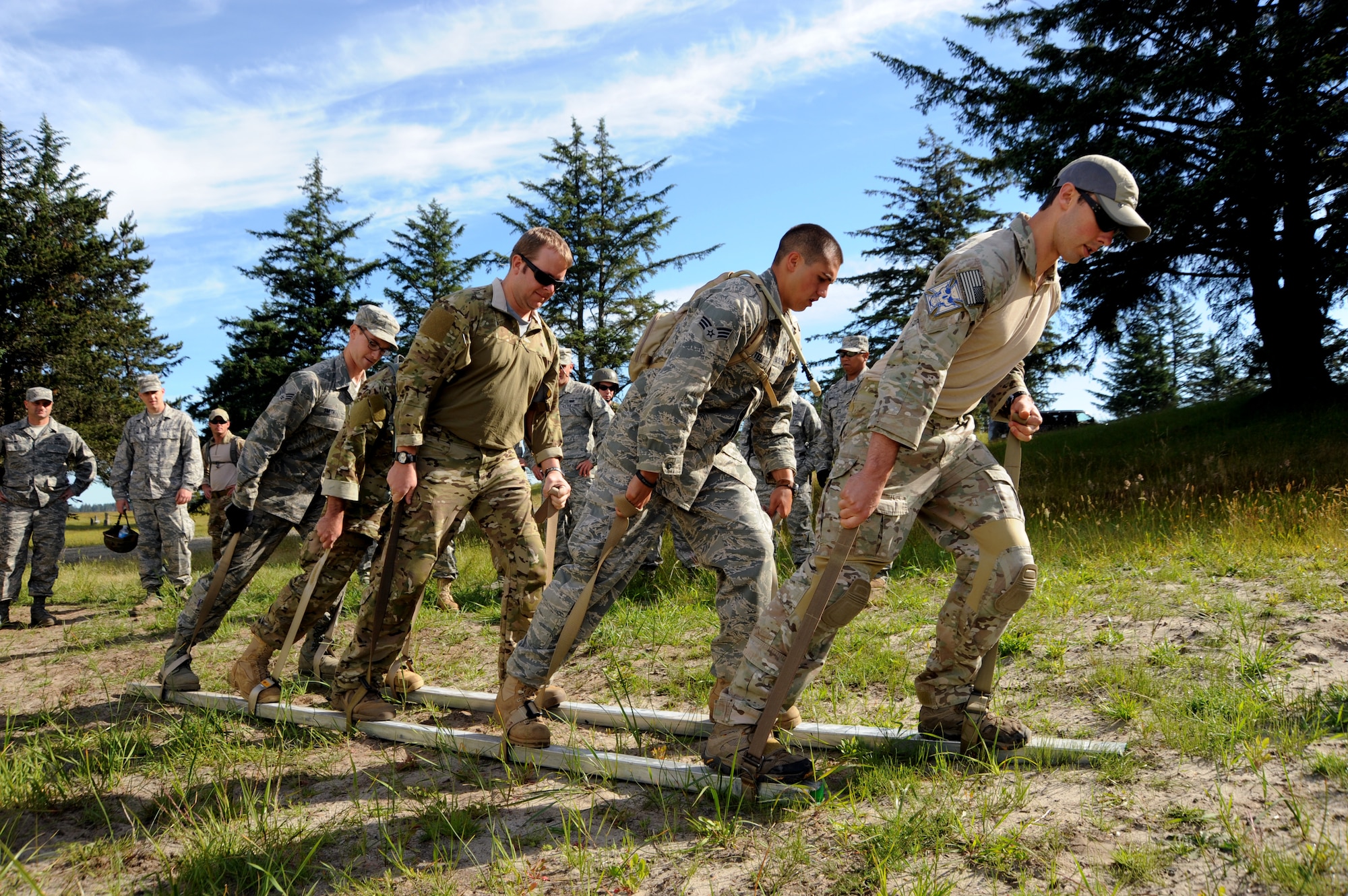 Airmen of the Oregon Combat Operations Group work together during the 'Monster Mash'  field training exercise, June 22, 2013 at Camp Rilea, Ore. The training was held over a five-day period in which the Combat Operations Group (COG) made up of four individual Oregon Air Guard units; 125th STS, 116th ACS, 270th ATCS and the 123rd WF. The focus of the training was to build unit morale, establish new professional networks and enhance military development. (Air National Guard photo by Tech. Sgt. John Hughel, 142nd Fighter Wing Public Affairs).