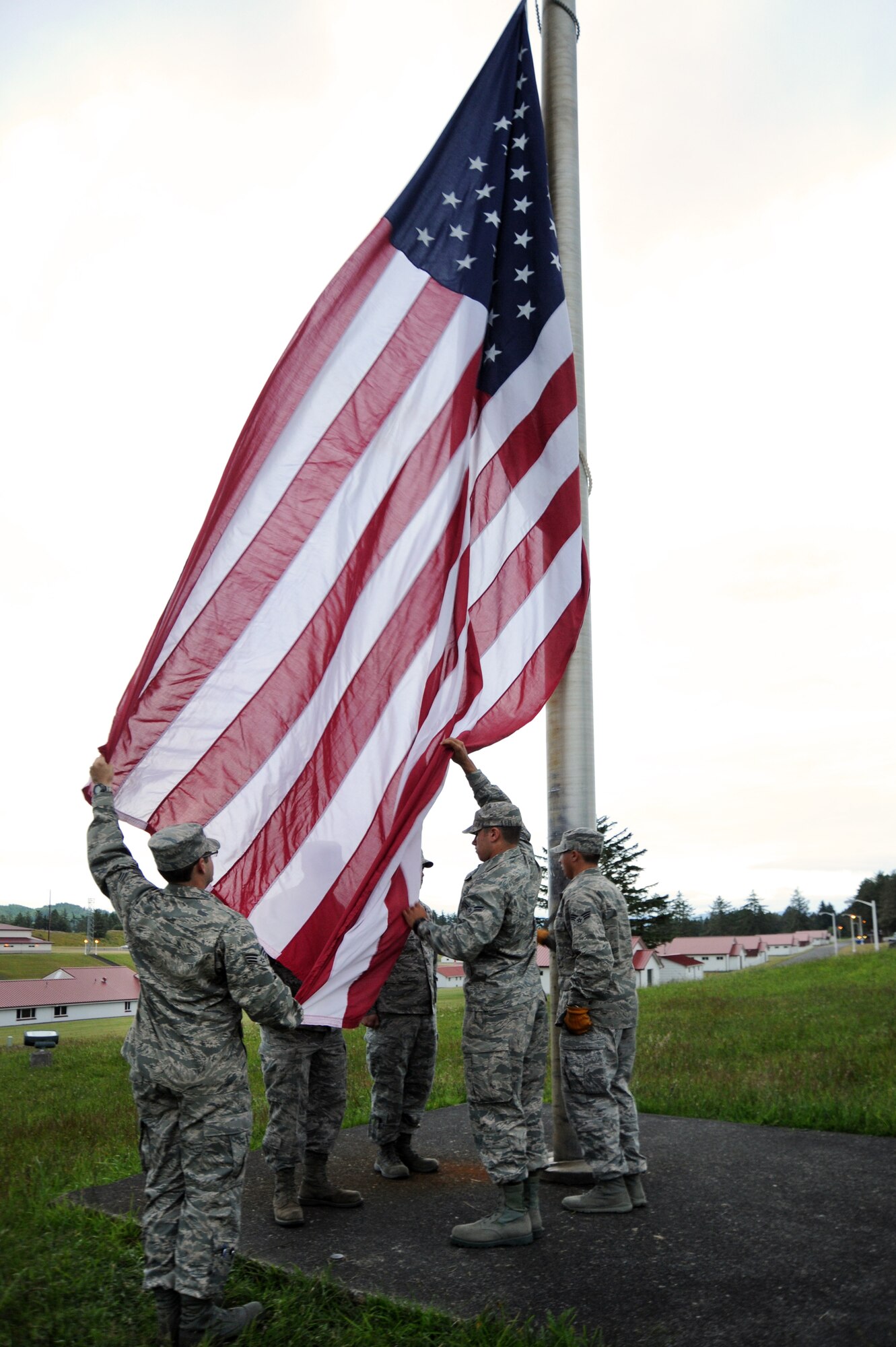 Airmen of the Combat Operations Group prepare to raise the colors during a morning reveille at Camp Rilea, Ore., June 21, 2013. (Air National Guard Photo by Tech. Sgt. John Hughel, 142nd Fighter Wing Public Affairs)